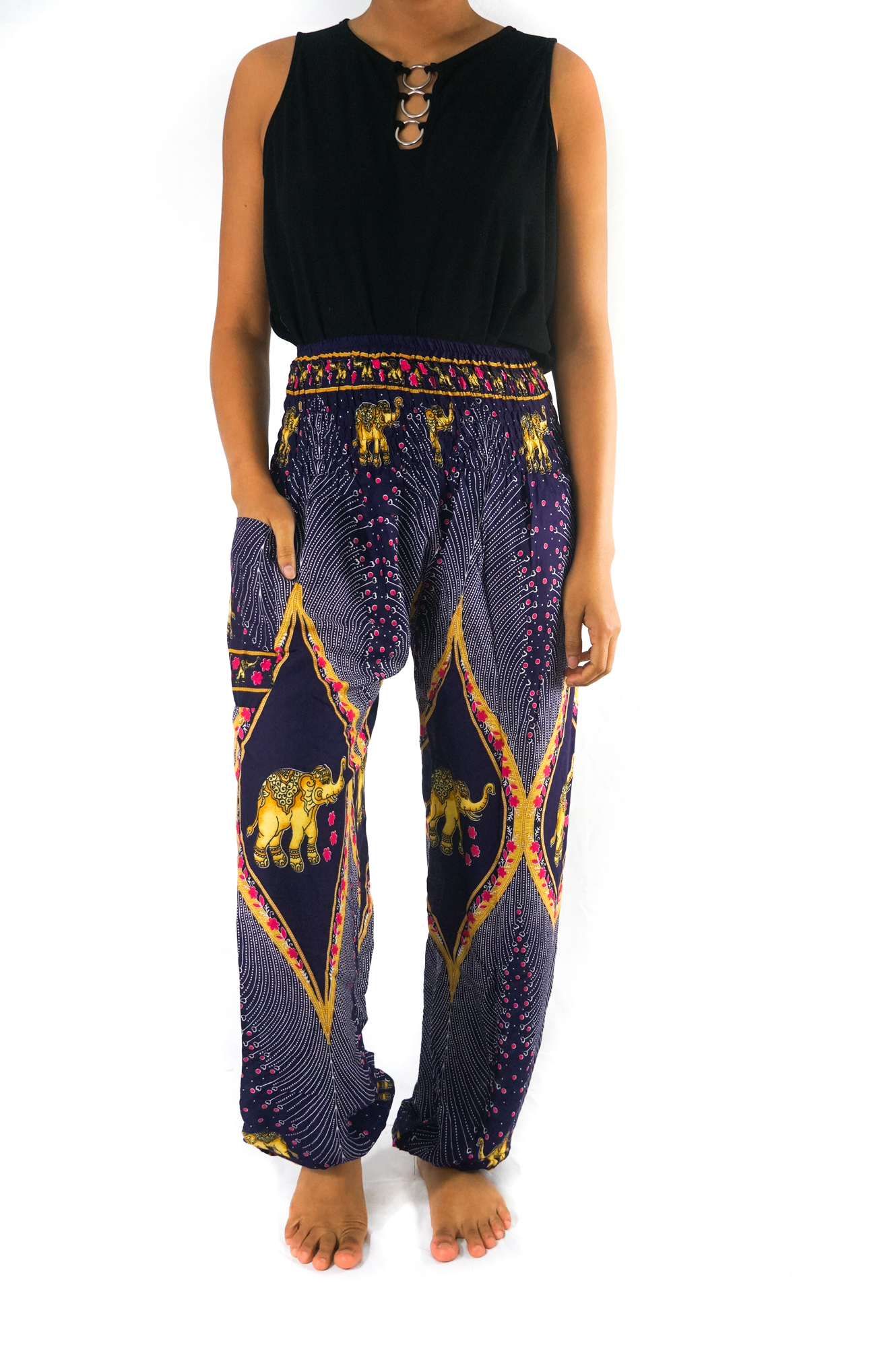 A pair of vibrant purple boho harem pants featuring intricate peacock and elephant patterns, made from lightweight rayon with an elastic waist and ankle.