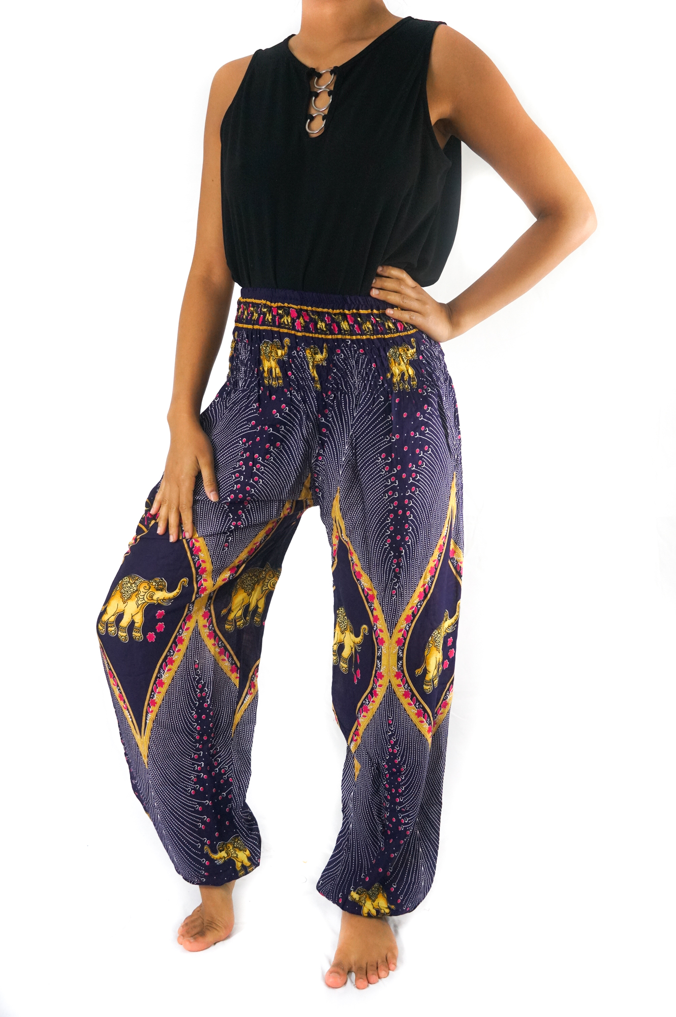 A pair of vibrant purple boho harem pants featuring intricate peacock and elephant patterns, made from lightweight rayon with an elastic waist and ankle.