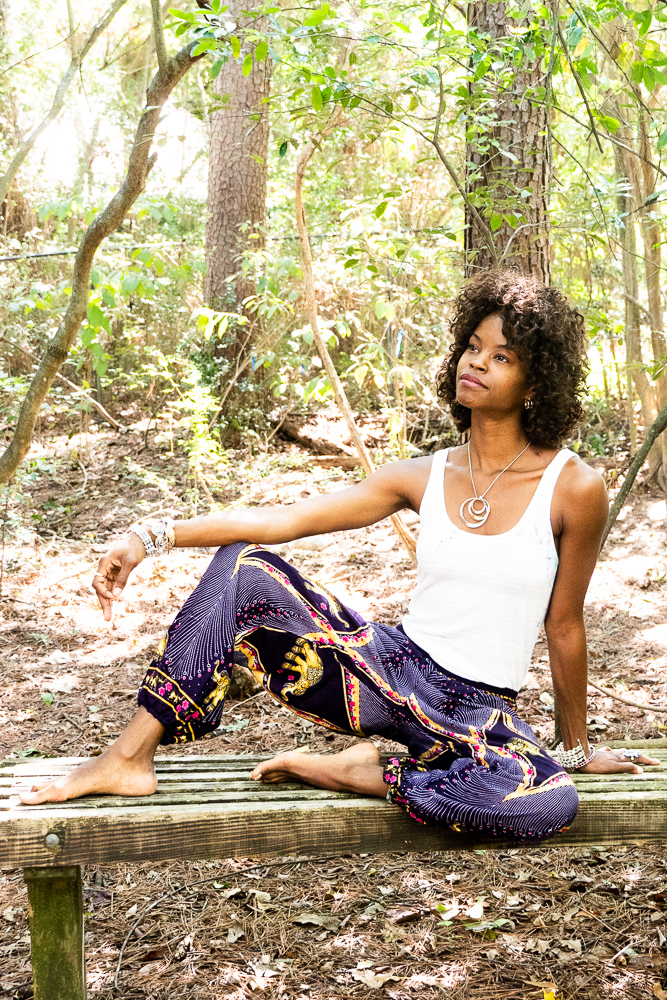 A pair of vibrant purple boho harem pants featuring intricate peacock and elephant patterns, made from lightweight rayon with an elastic waist and ankle.