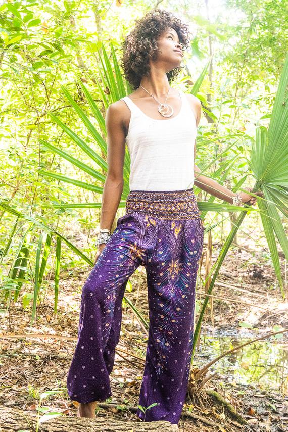 Purple PEACOCK Harem Pants for women, featuring a vibrant peacock print, elastic waist and ankle, and a side pocket, made from lightweight rayon.