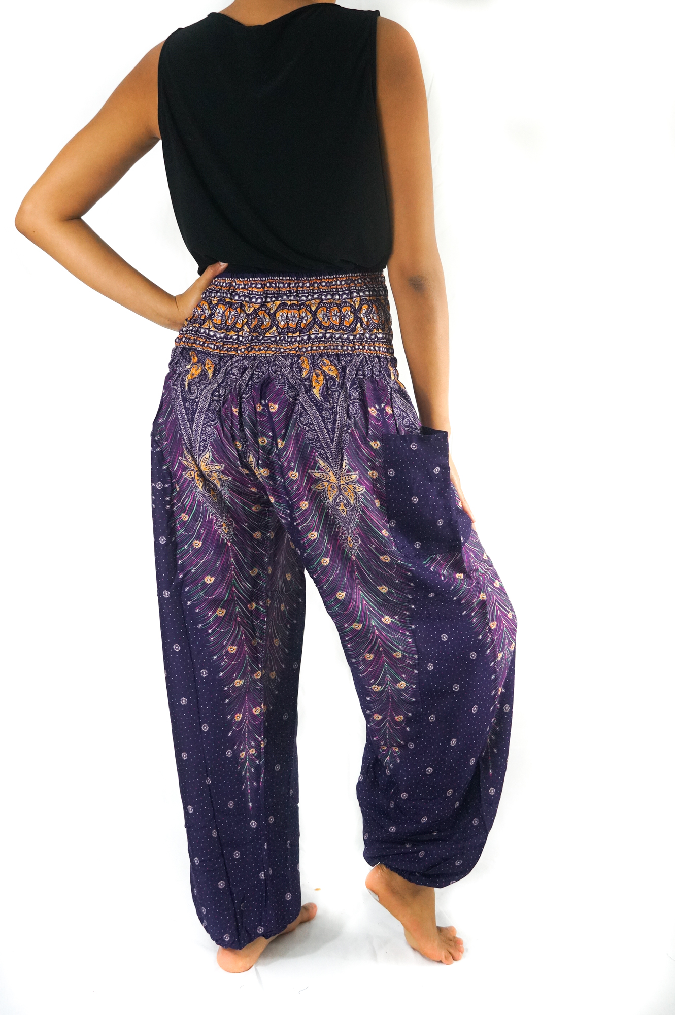 Purple PEACOCK Harem Pants for women, featuring a vibrant peacock print, elastic waist and ankle, and a side pocket, made from lightweight rayon.