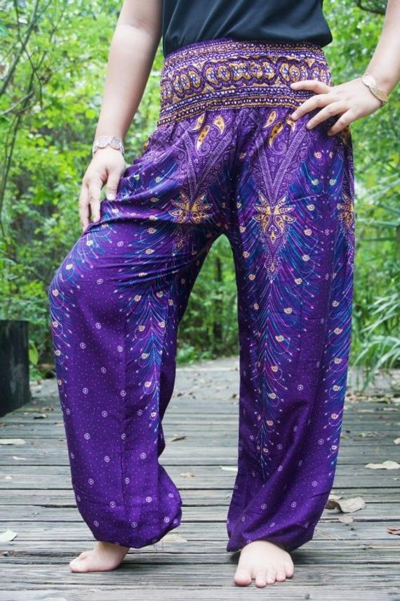 Purple PEACOCK Harem Pants for women, featuring a vibrant peacock print, elastic waist and ankle, and a side pocket, made from lightweight rayon.