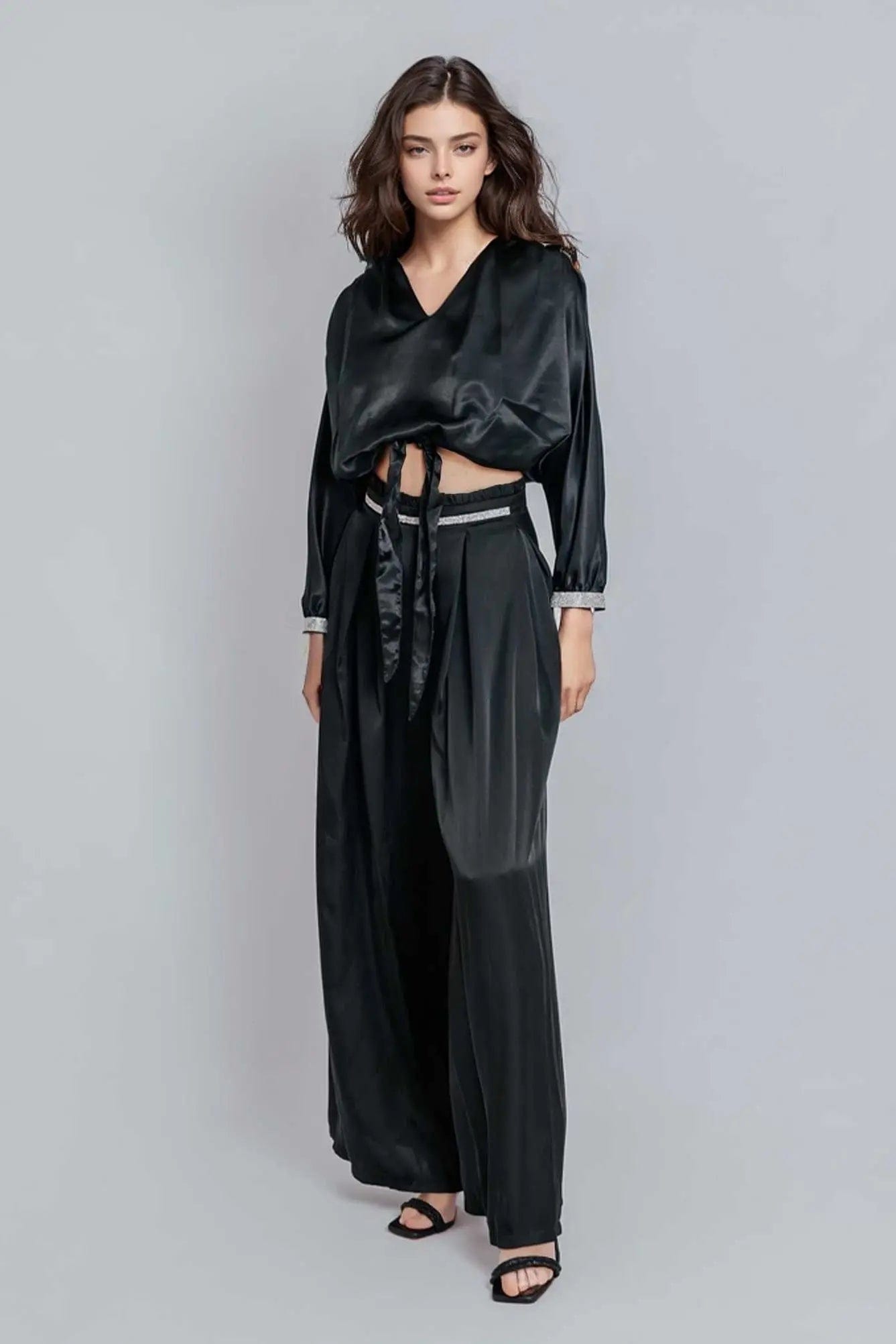 Reed Wide Leg Pants in black, featuring a high-rise design and wide-leg silhouette, made from a luxurious rayon satin blend.