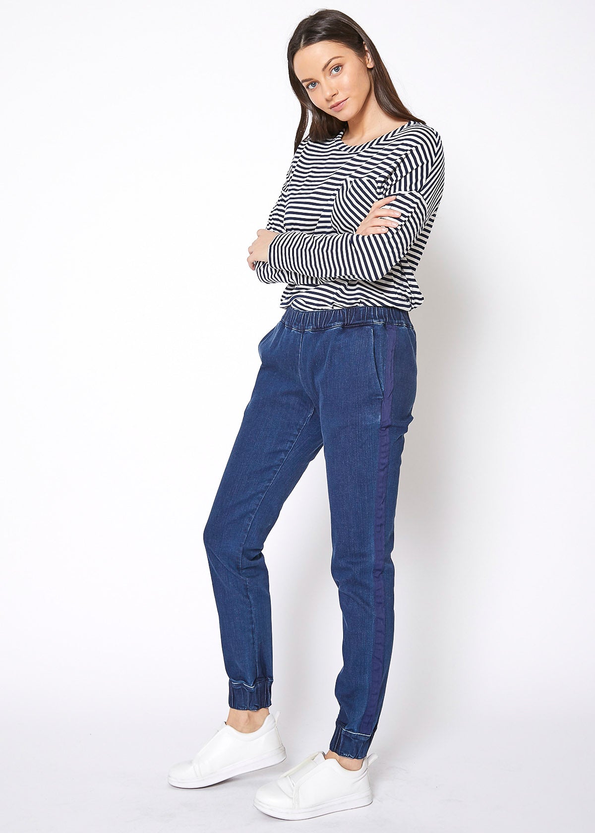 Ro & De Women's Elastic Cuffed Denim Joggers featuring a mid-rise fit, elastic cuffs, and stylish side binding in heavy stretch denim.