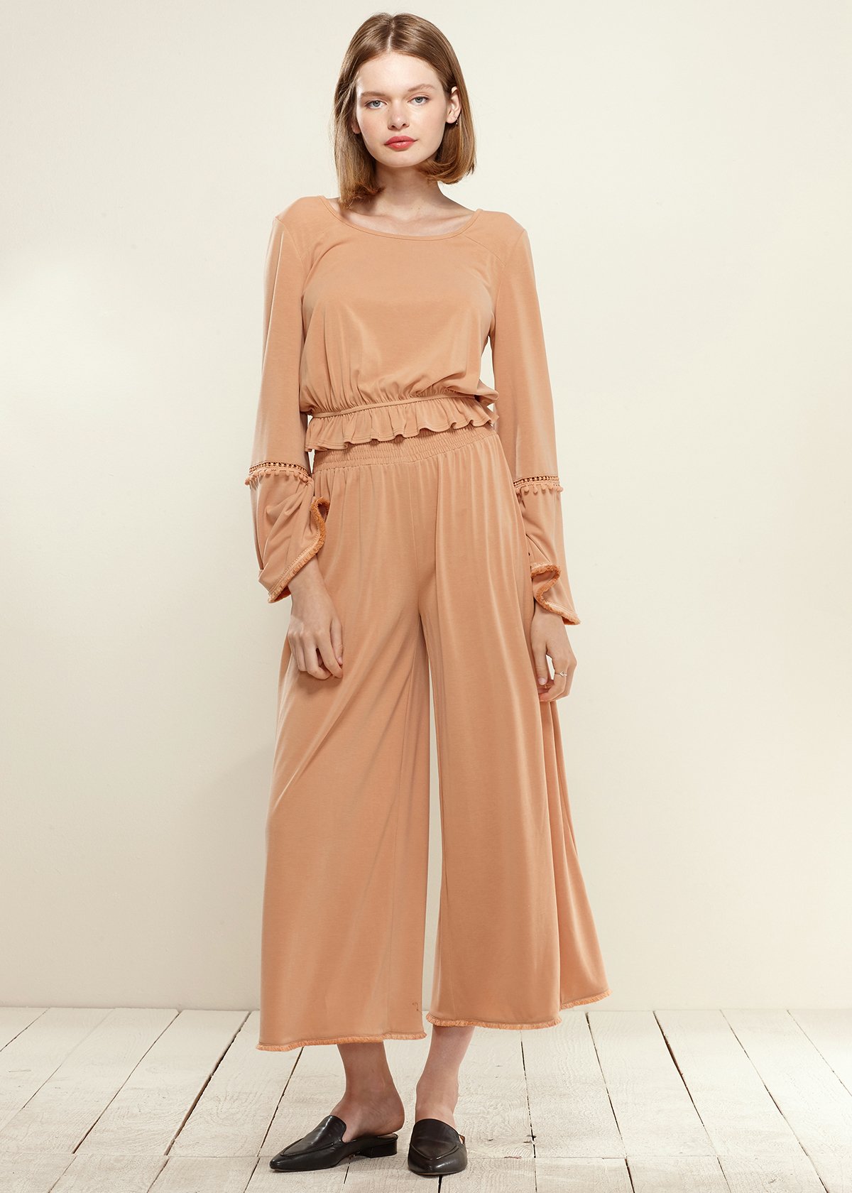 Smocked Waist Wide Leg Palazzo Pants in Apricot, showcasing a stylish design with a smocked waist and wide legs, made from soft cupro knit fabric.