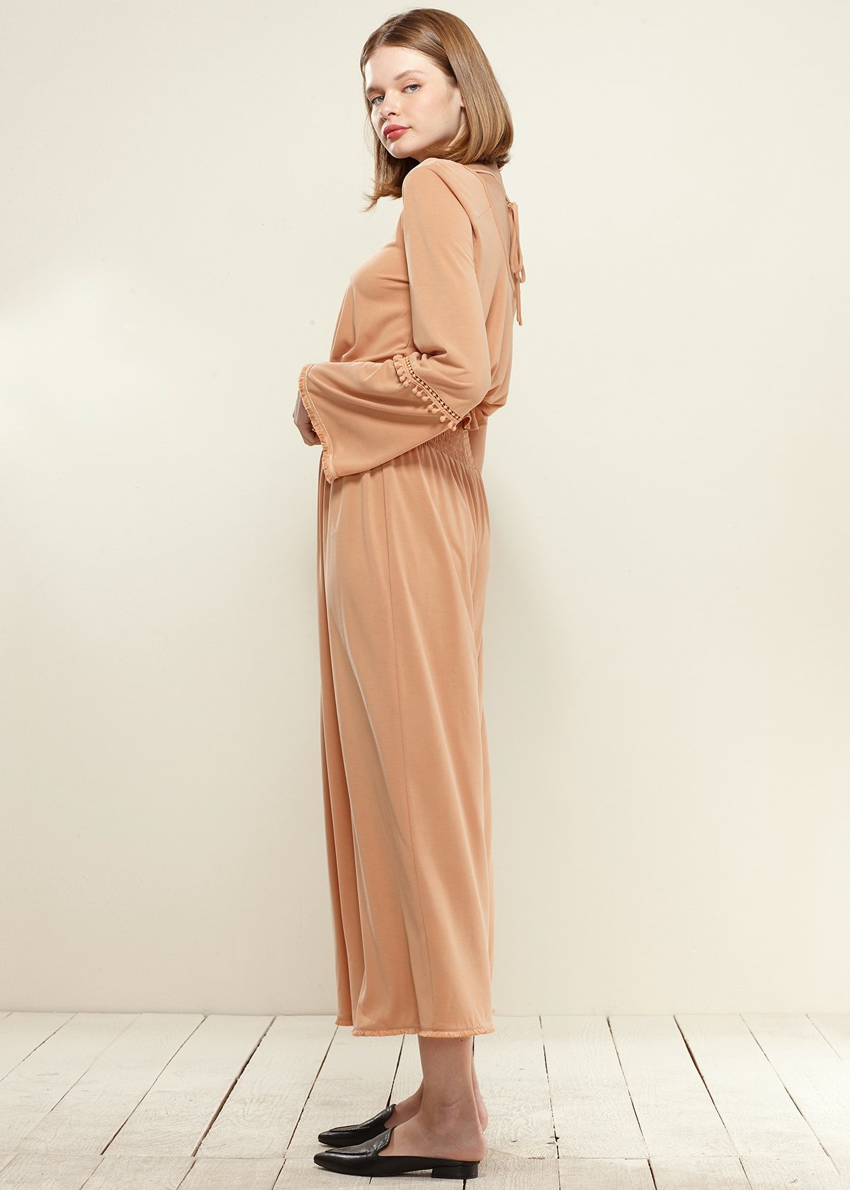 Smocked Waist Wide Leg Palazzo Pants in Apricot, showcasing a stylish design with a smocked waist and wide legs, made from soft cupro knit fabric.