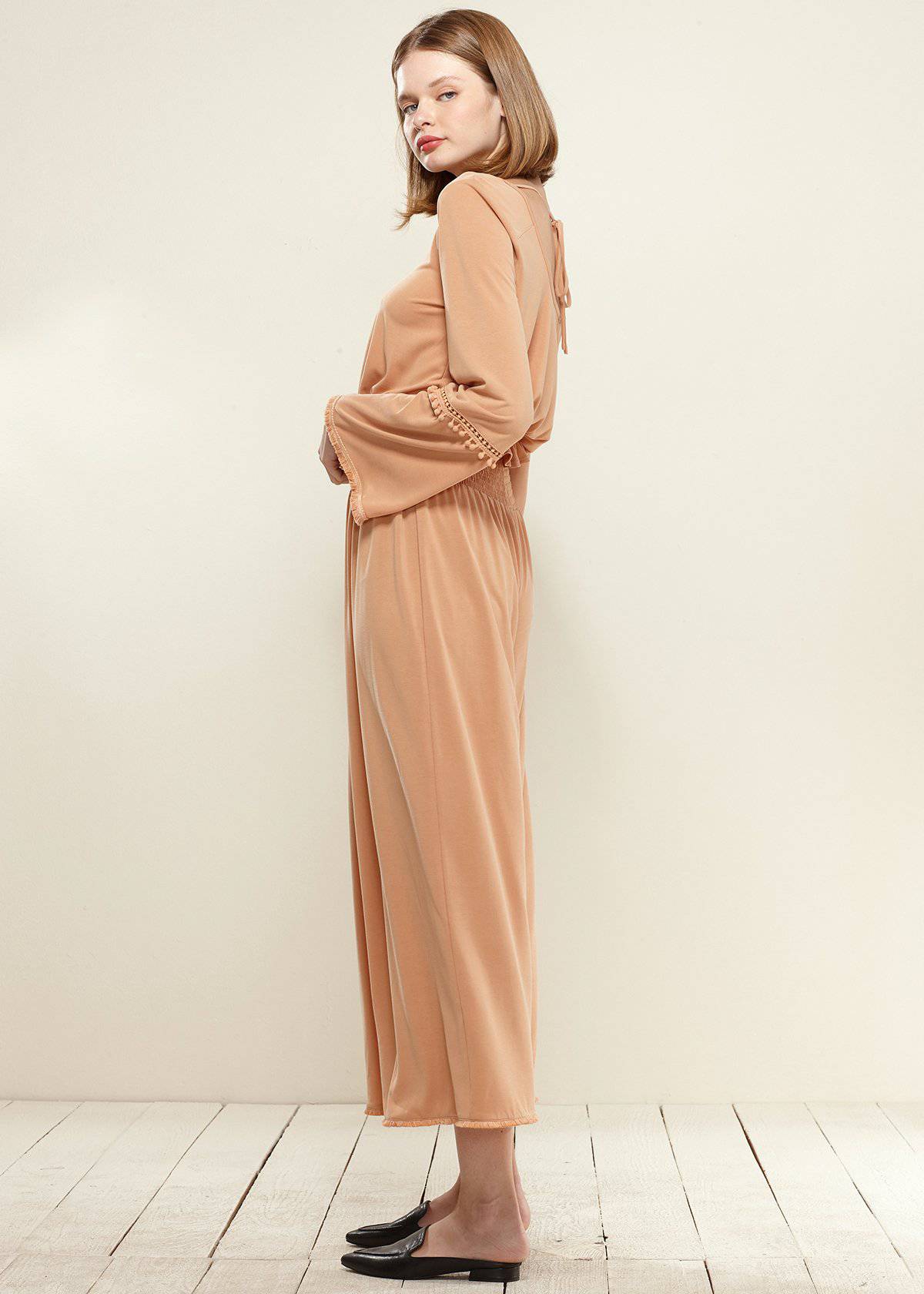 Smocked Waist Wide Leg Palazzo Pants in Apricot, showcasing a stylish design with a smocked waist and wide legs, made from soft cupro knit fabric.