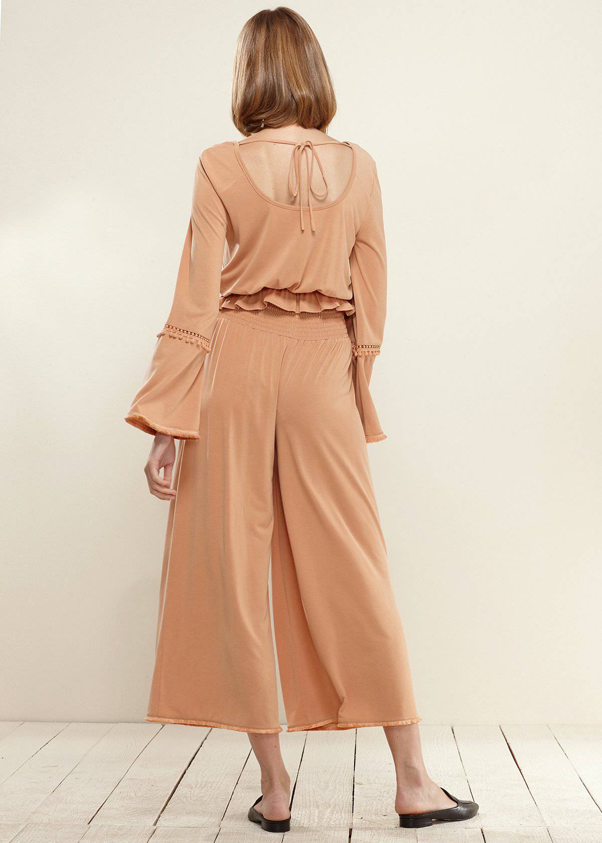 Smocked Waist Wide Leg Palazzo Pants in Apricot, showcasing a stylish design with a smocked waist and wide legs, made from soft cupro knit fabric.