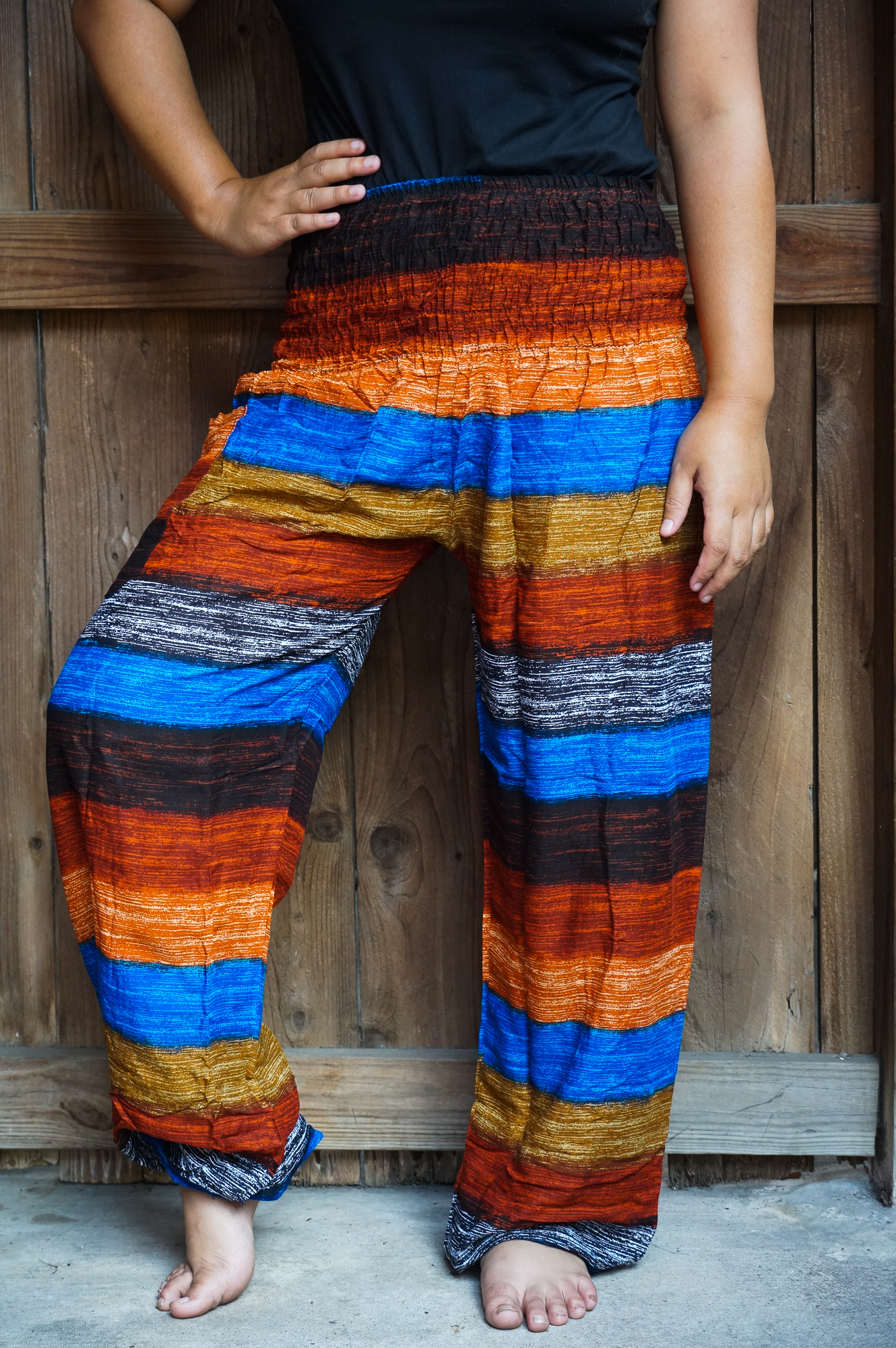 Striped harem pants made of lightweight rayon, featuring an elastic waist and ankles, perfect for casual wear and yoga.