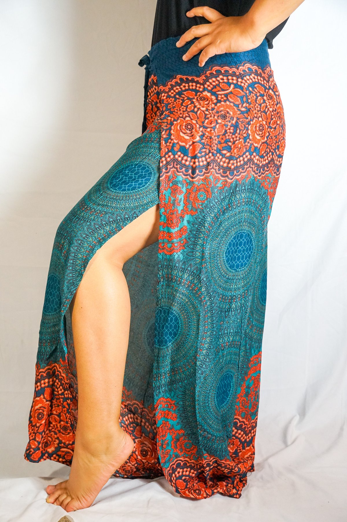 Teal Palazzo Wrap Pants featuring a tie-dye pattern, open leg design, and two connected panels for a bohemian look.