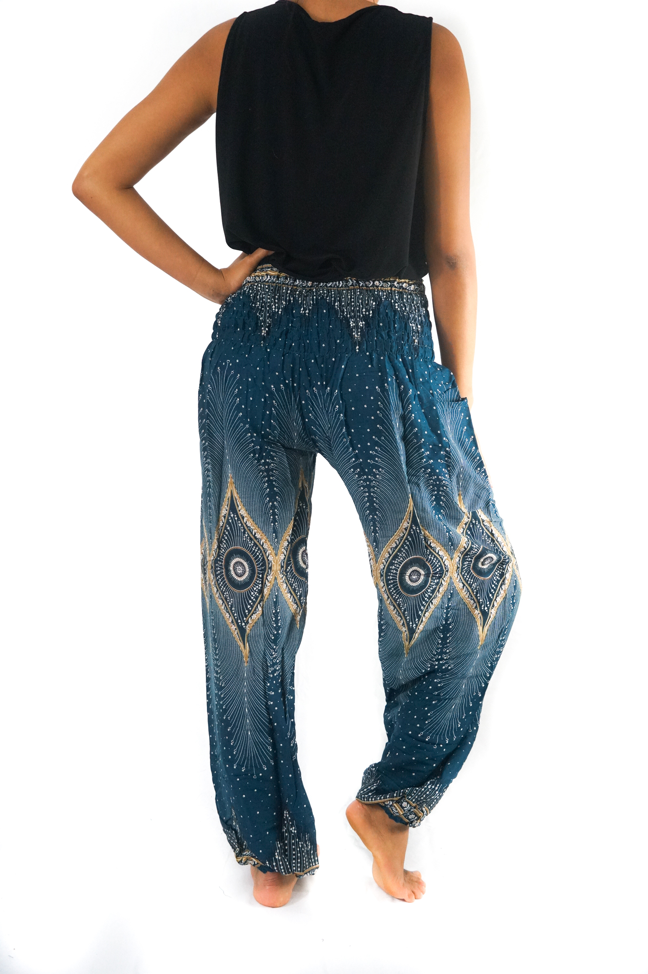 Teal PEACOCK Women Boho Pants featuring a vibrant peacock design, elastic waist, and ankle, made from lightweight breathable rayon fabric.