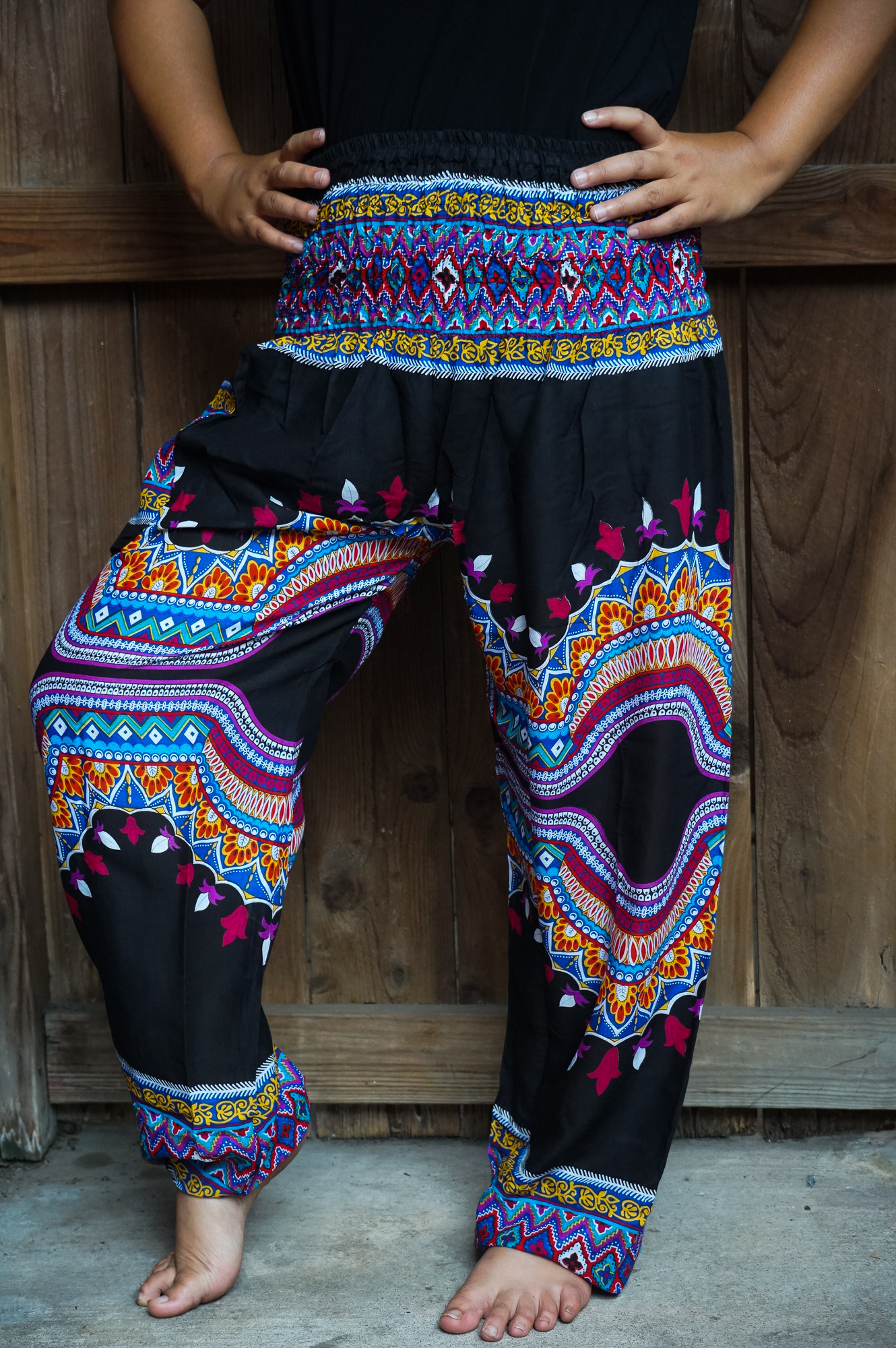 A pair of vibrant Tribal Harem Pants made from 100% rayon, featuring an elastic waist and ankle, perfect for bohemian style and comfort.