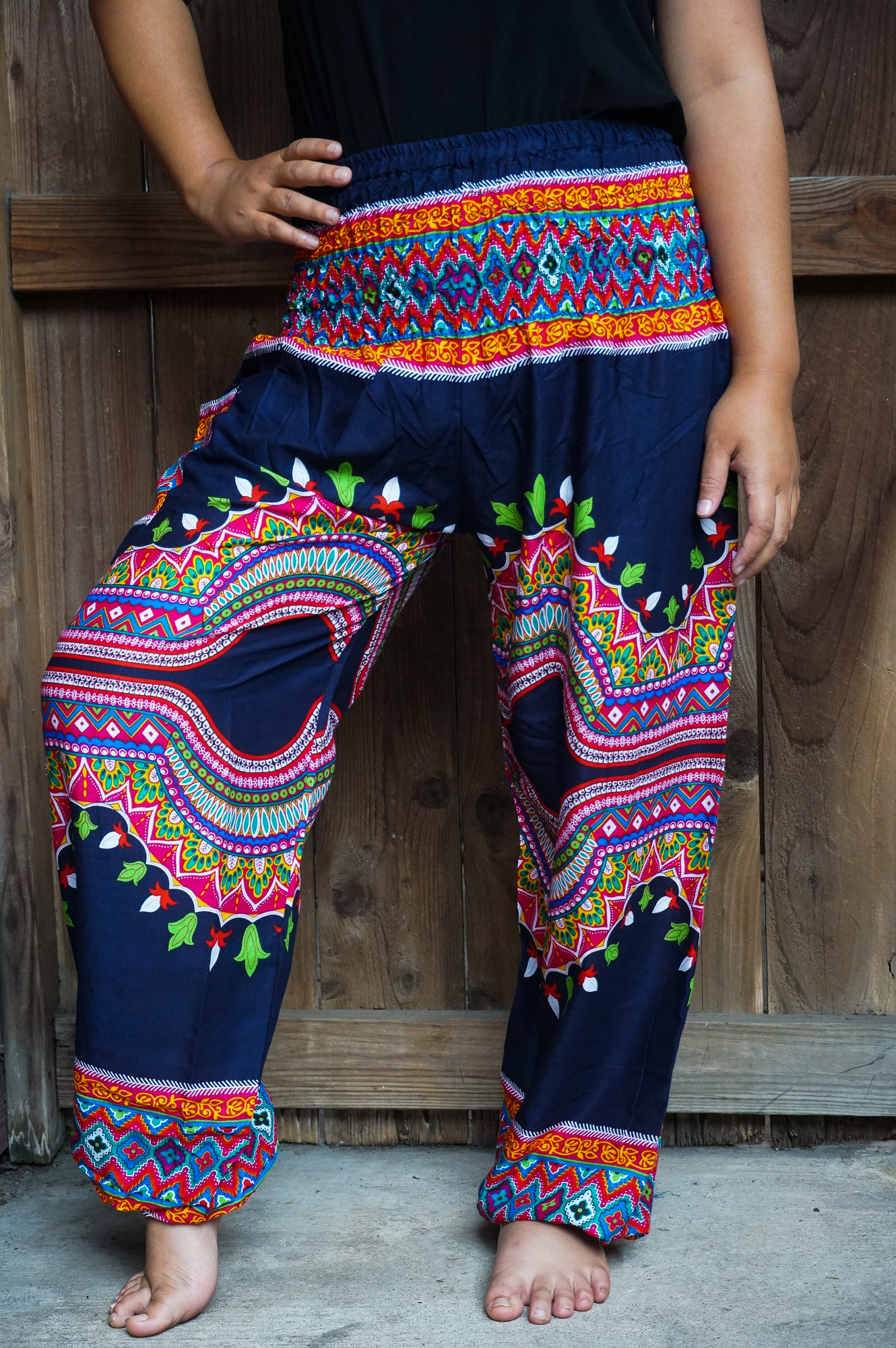 A pair of colorful Tribal Harem Pants made from 100% rayon, featuring an elastic waist and ankle, perfect for a bohemian style.