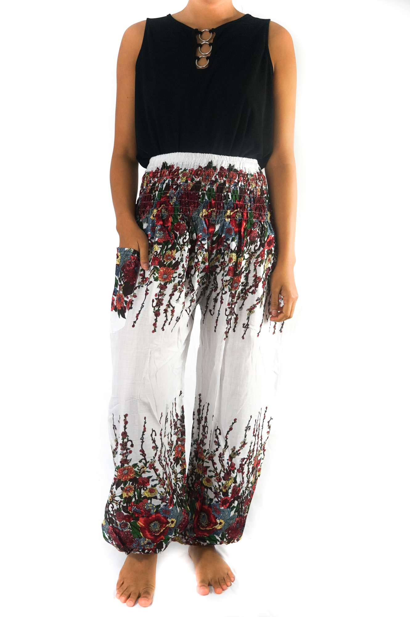 A pair of White Floral Women Boho Pants featuring a vibrant floral pattern, elastic waist, and ankle cuffs, perfect for yoga and casual wear.