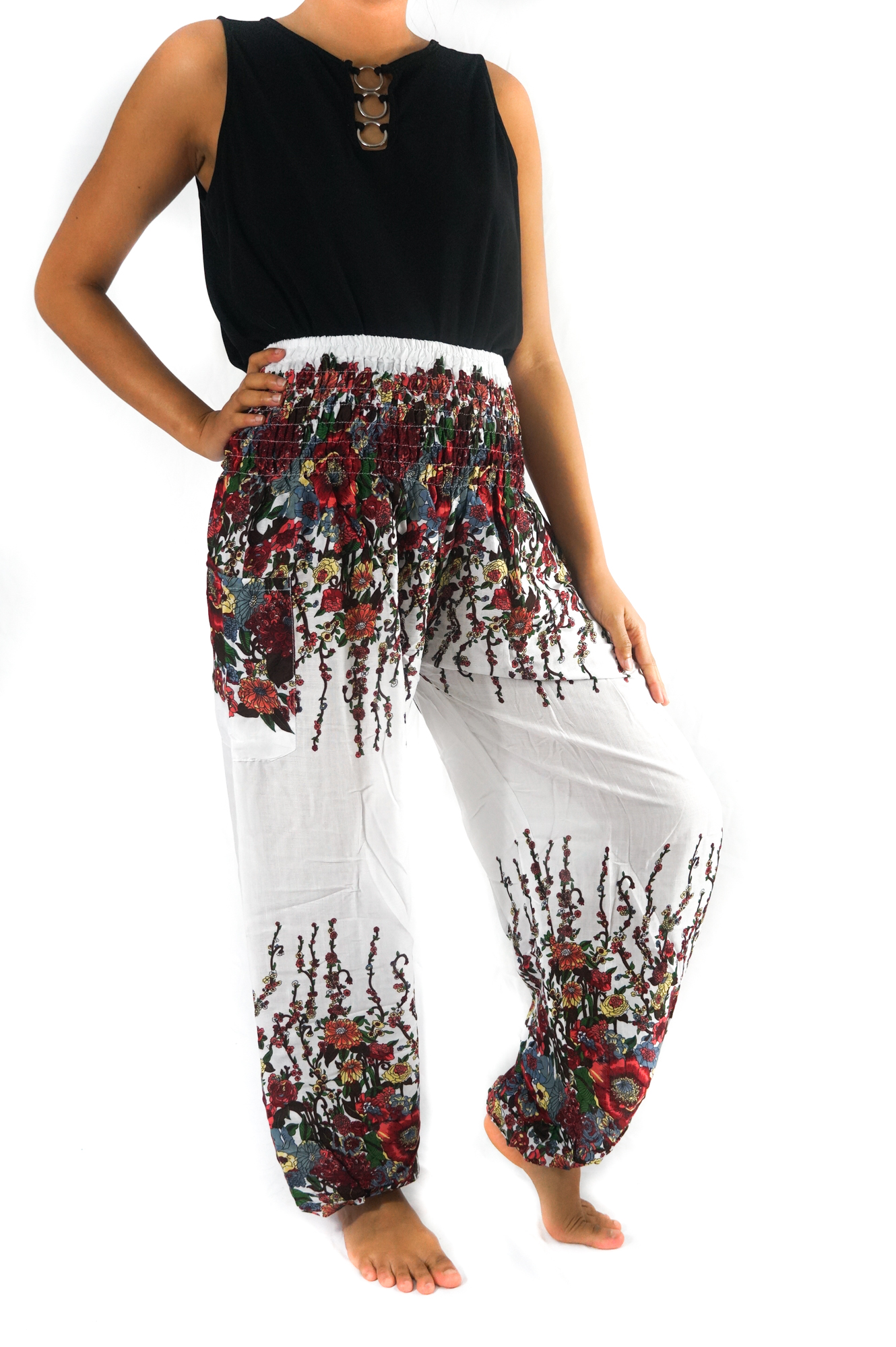 A pair of White Floral Women Boho Pants featuring a vibrant floral pattern, elastic waist, and ankle cuffs, perfect for yoga and casual wear.