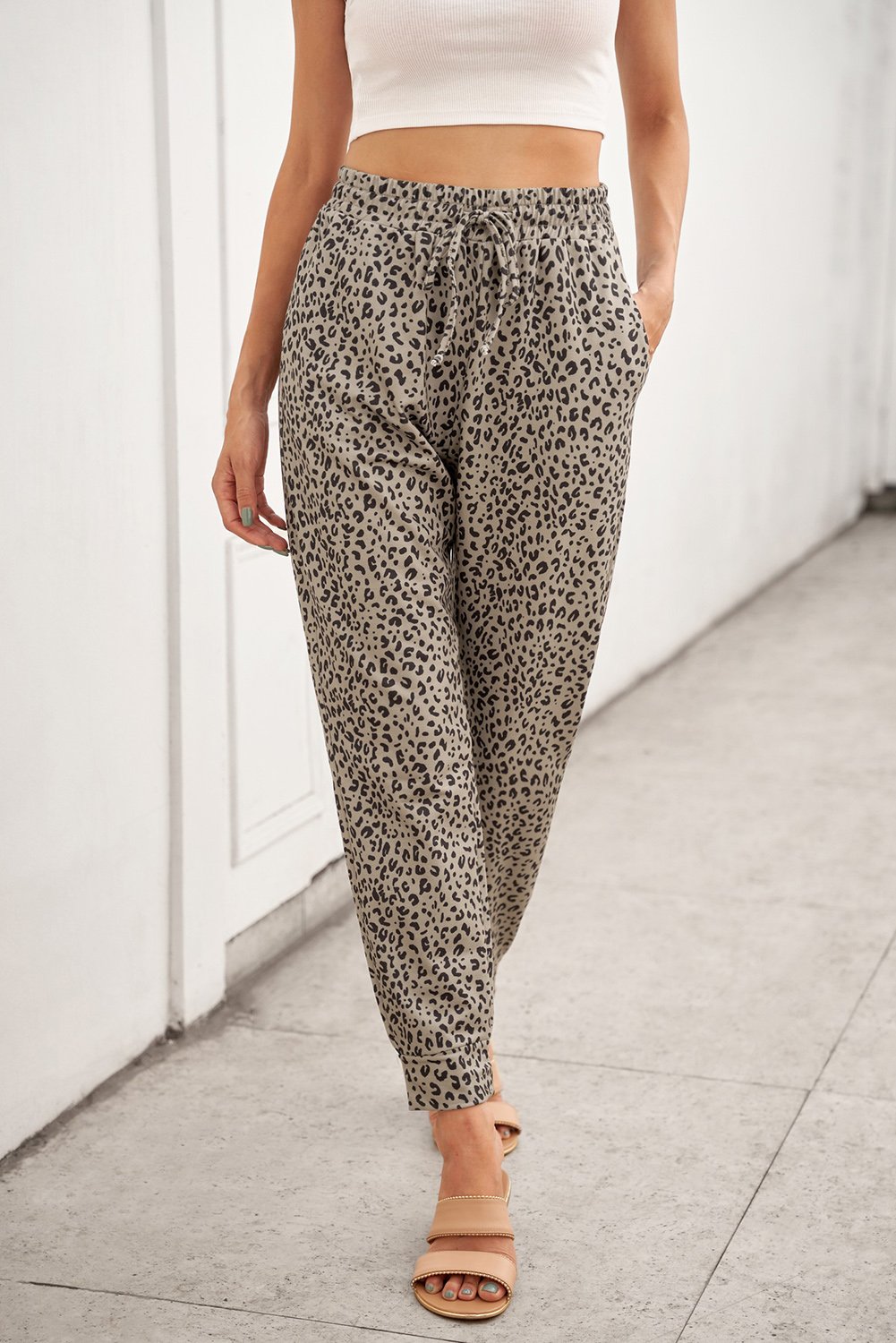 Women wearing casual khaki breezy leopard joggers, showcasing stylish leopard print and adjustable waist.