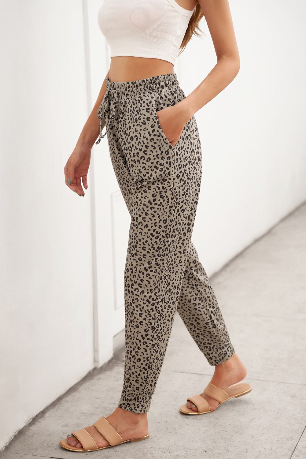 Women wearing casual khaki breezy leopard joggers, showcasing stylish leopard print and adjustable waist.