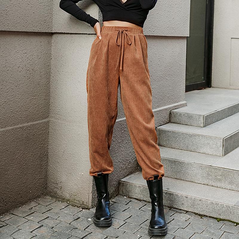 Women fashion high waist harem pants in solid brown, featuring an elastic waist and stylish sashes, perfect for casual wear.