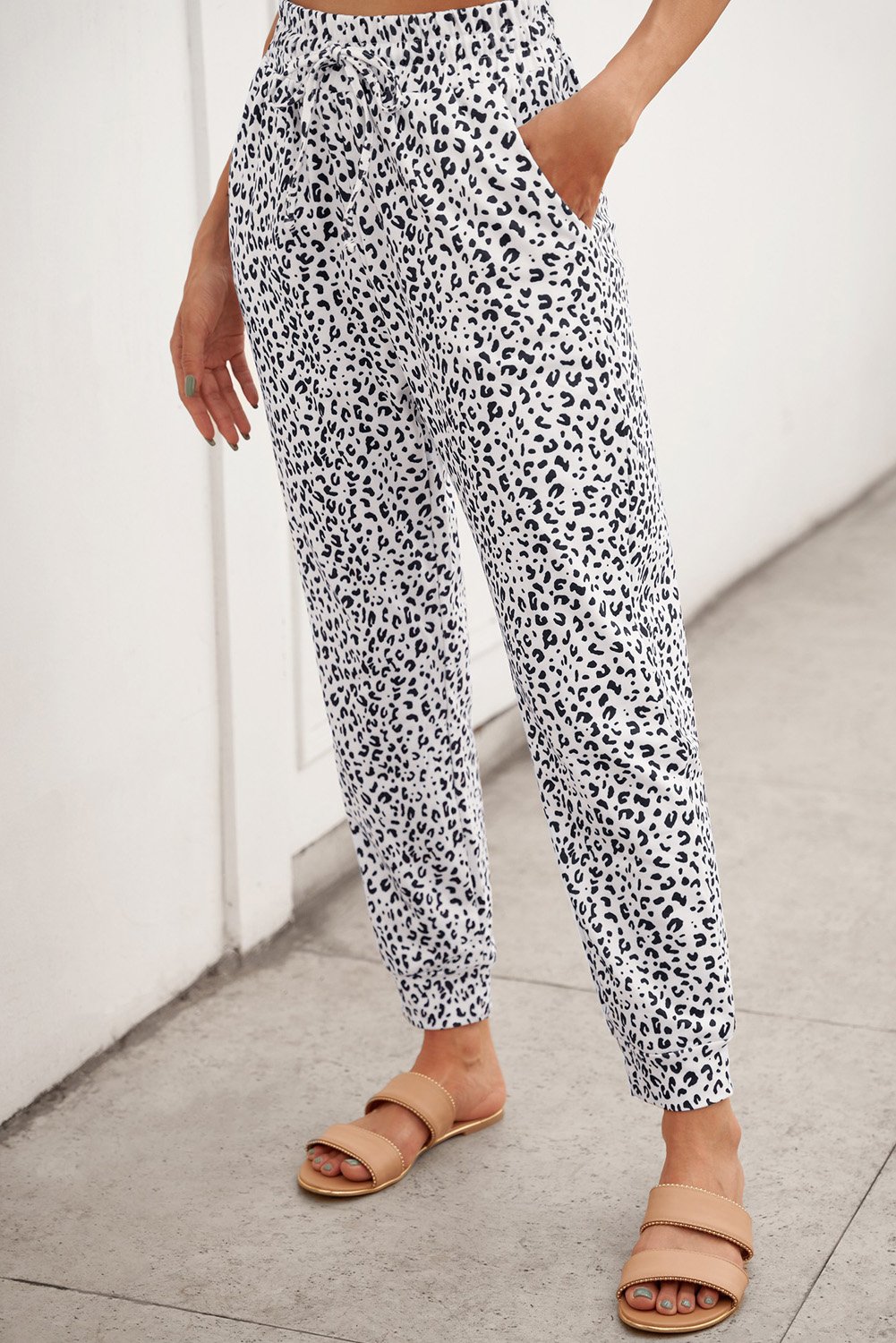 Women's Casual White Breezy Leopard Joggers featuring a stylish leopard print and adjustable smocked waist for a comfortable fit.