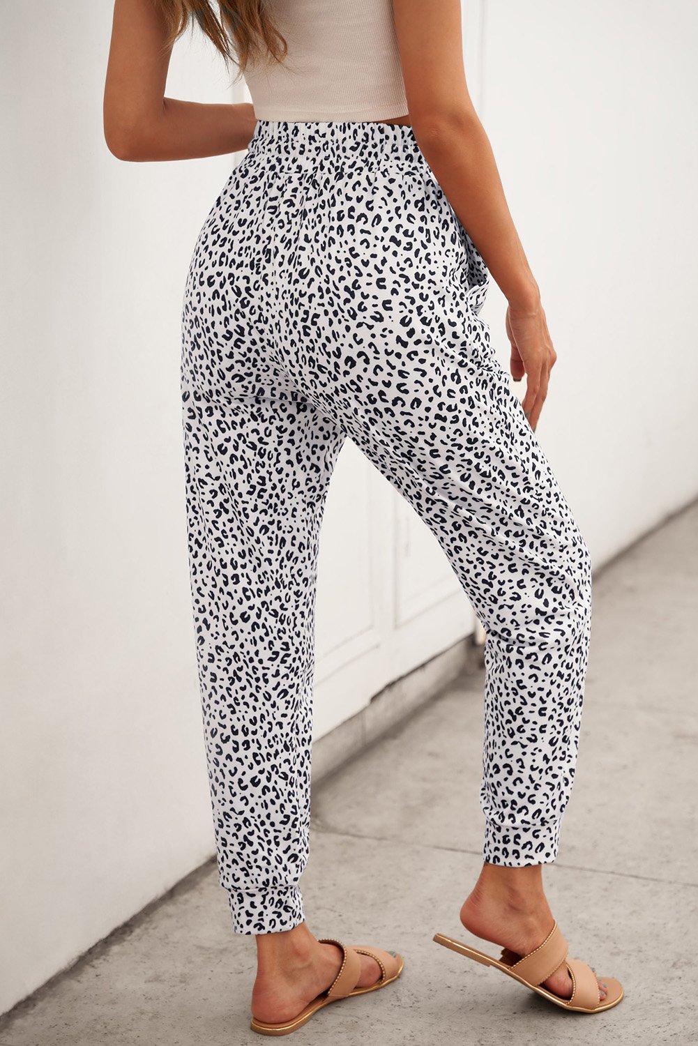 Women's Casual White Breezy Leopard Joggers featuring a stylish leopard print and adjustable smocked waist for a comfortable fit.