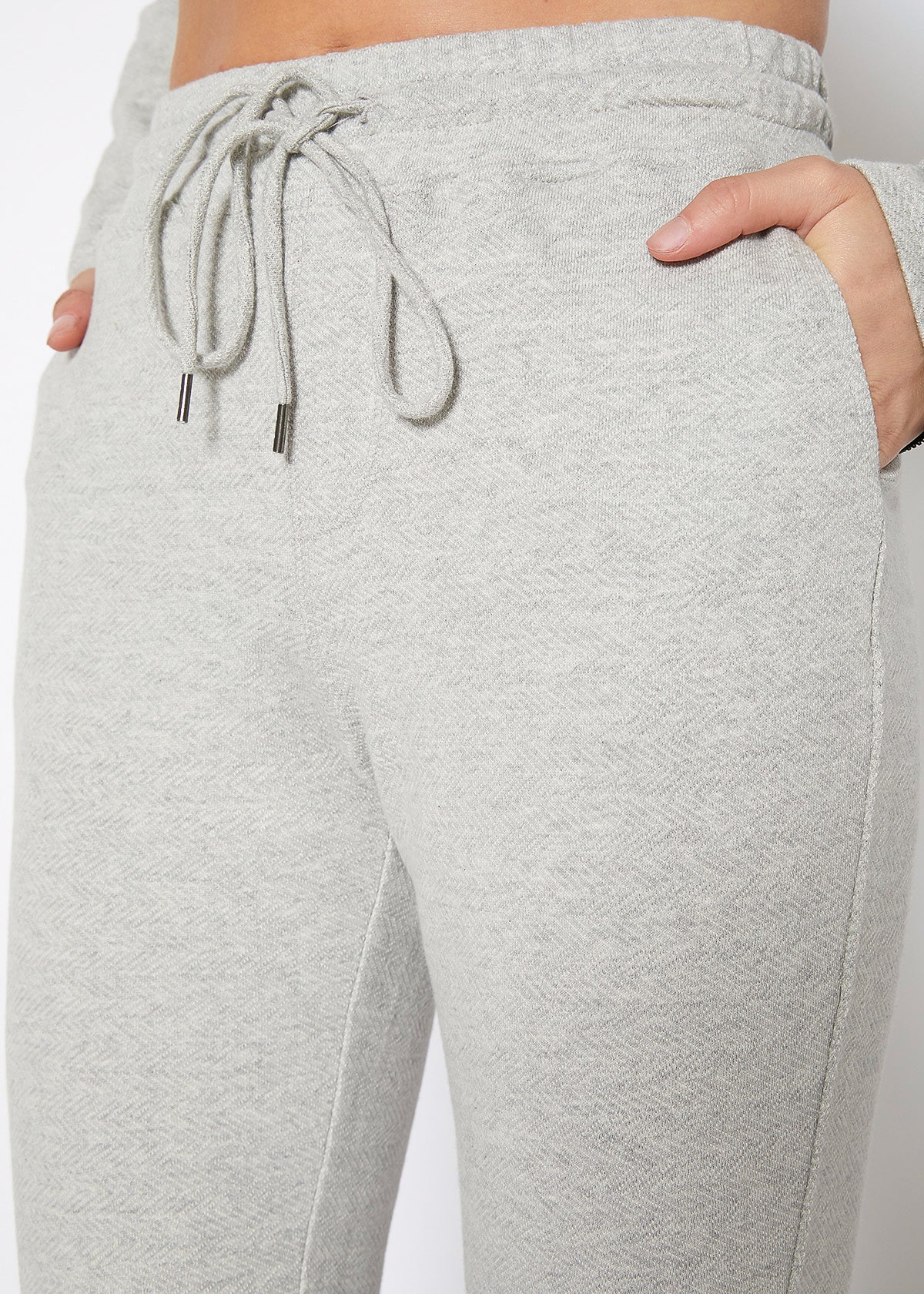 Women's Heather Grey Drawstring Waist Fitted Jogger Pants with Zipper Hem, showcasing a casual and stylish design.