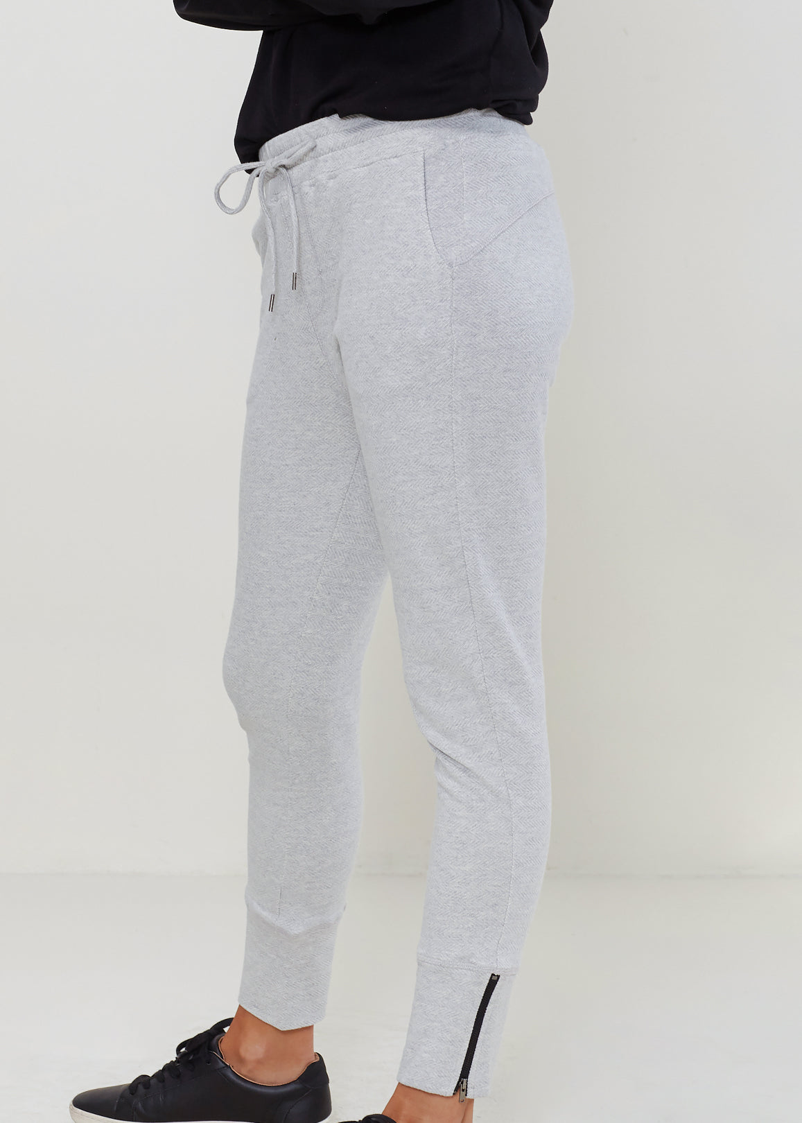 Women's Heather Grey Drawstring Waist Fitted Jogger Pants with Zipper Hem, showcasing a casual and stylish design.