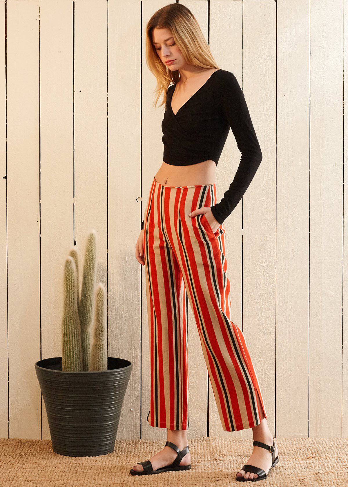 Women's hi-waisted cropped pants in vibrant poppy red stripe with side pockets and rear zipper detail.