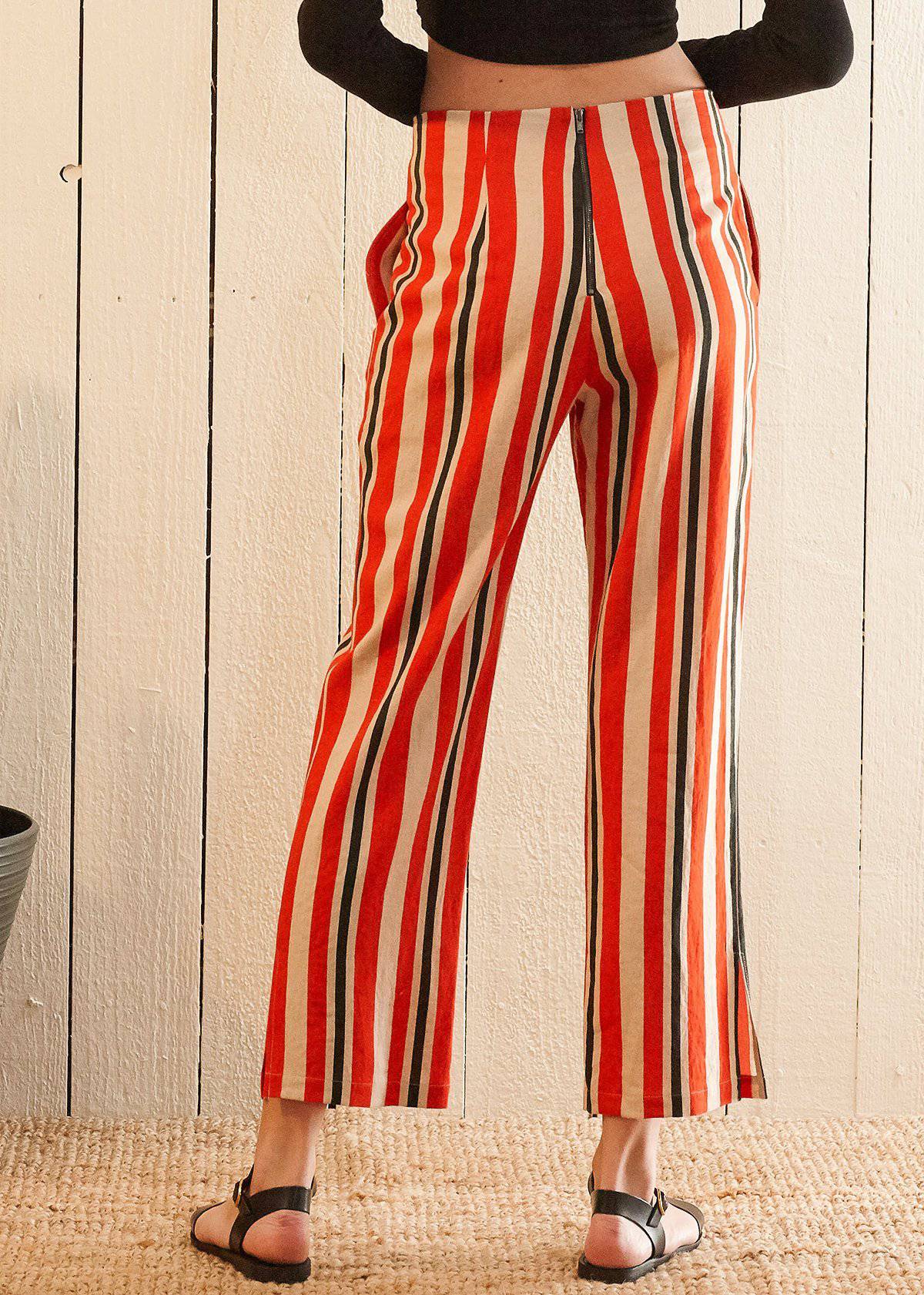 Women's hi-waisted cropped pants in vibrant poppy red stripe with side pockets and rear zipper detail.