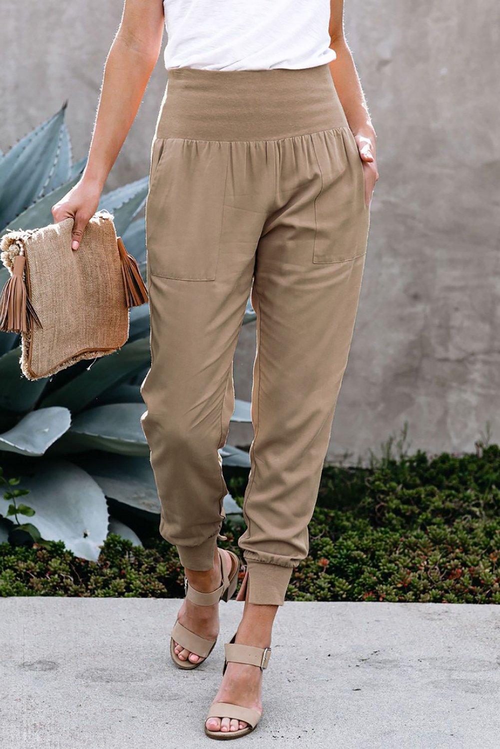 Women's khaki joggers featuring a wide waistband and slanted pockets, perfect for casual wear and workouts.