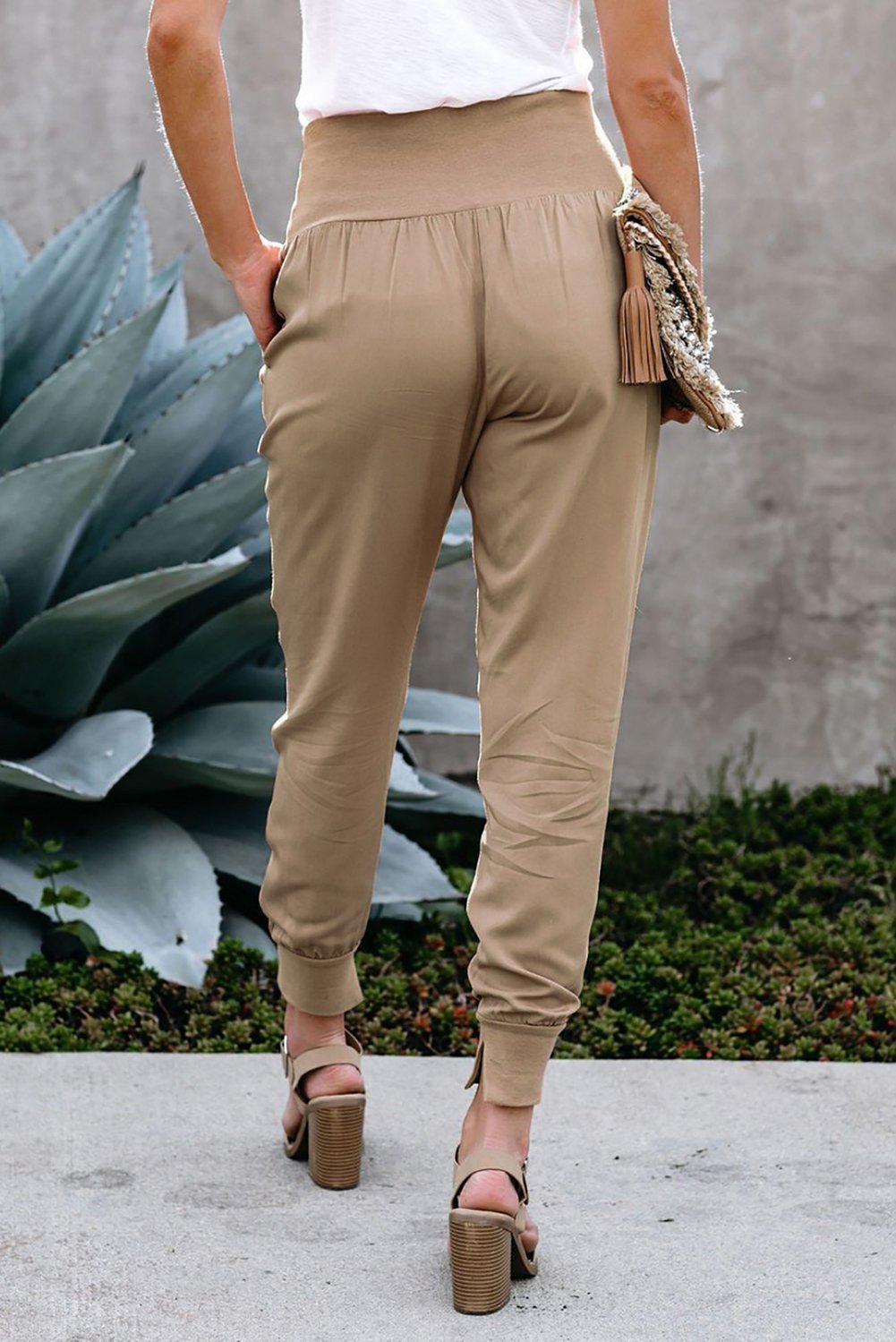 Women's khaki joggers featuring a wide waistband and slanted pockets, perfect for casual wear and workouts.