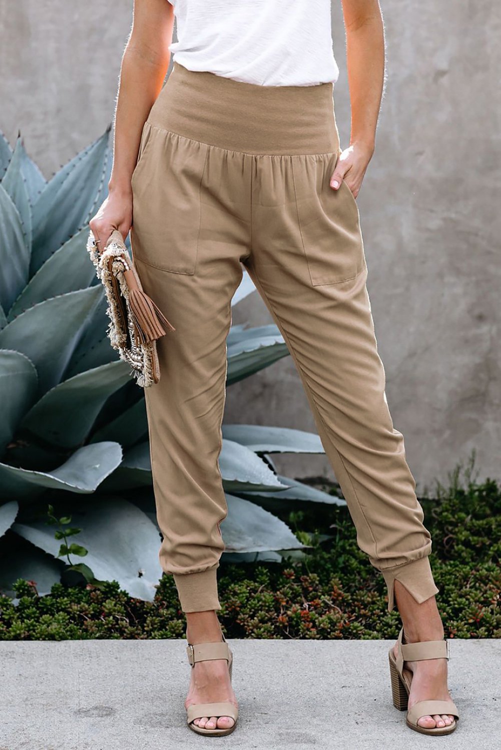 Women's khaki joggers featuring a wide waistband and slanted pockets, perfect for casual wear and workouts.