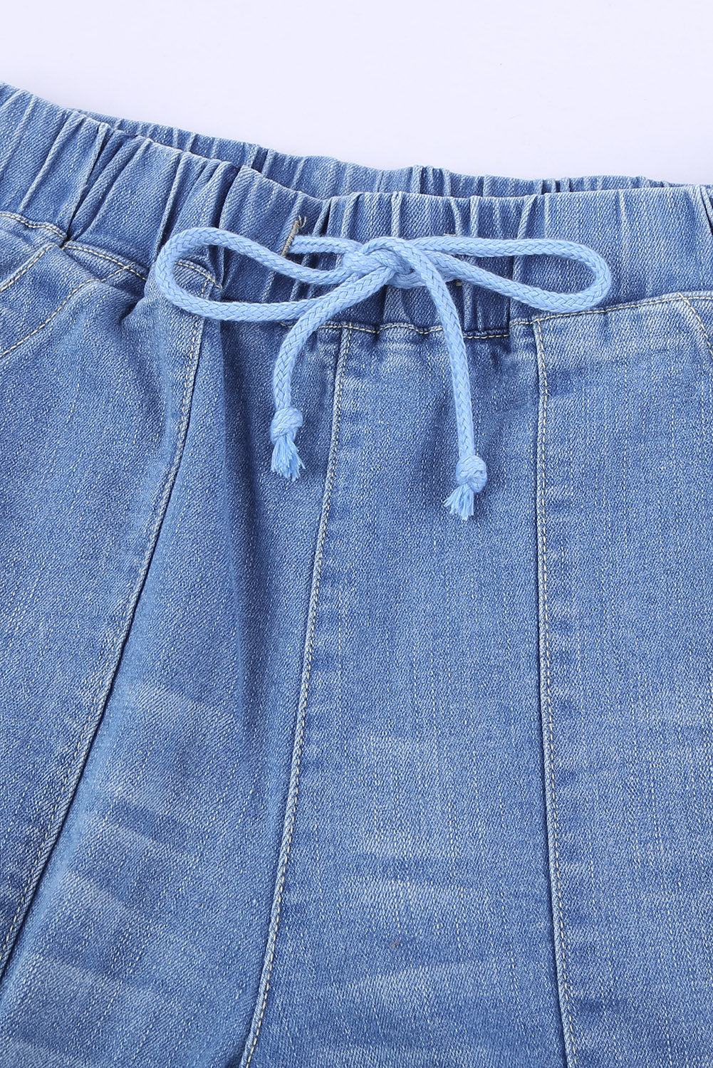 A pair of women's sky blue pocketed distressed jean joggers featuring an elastic waistband and stylish ripped design.