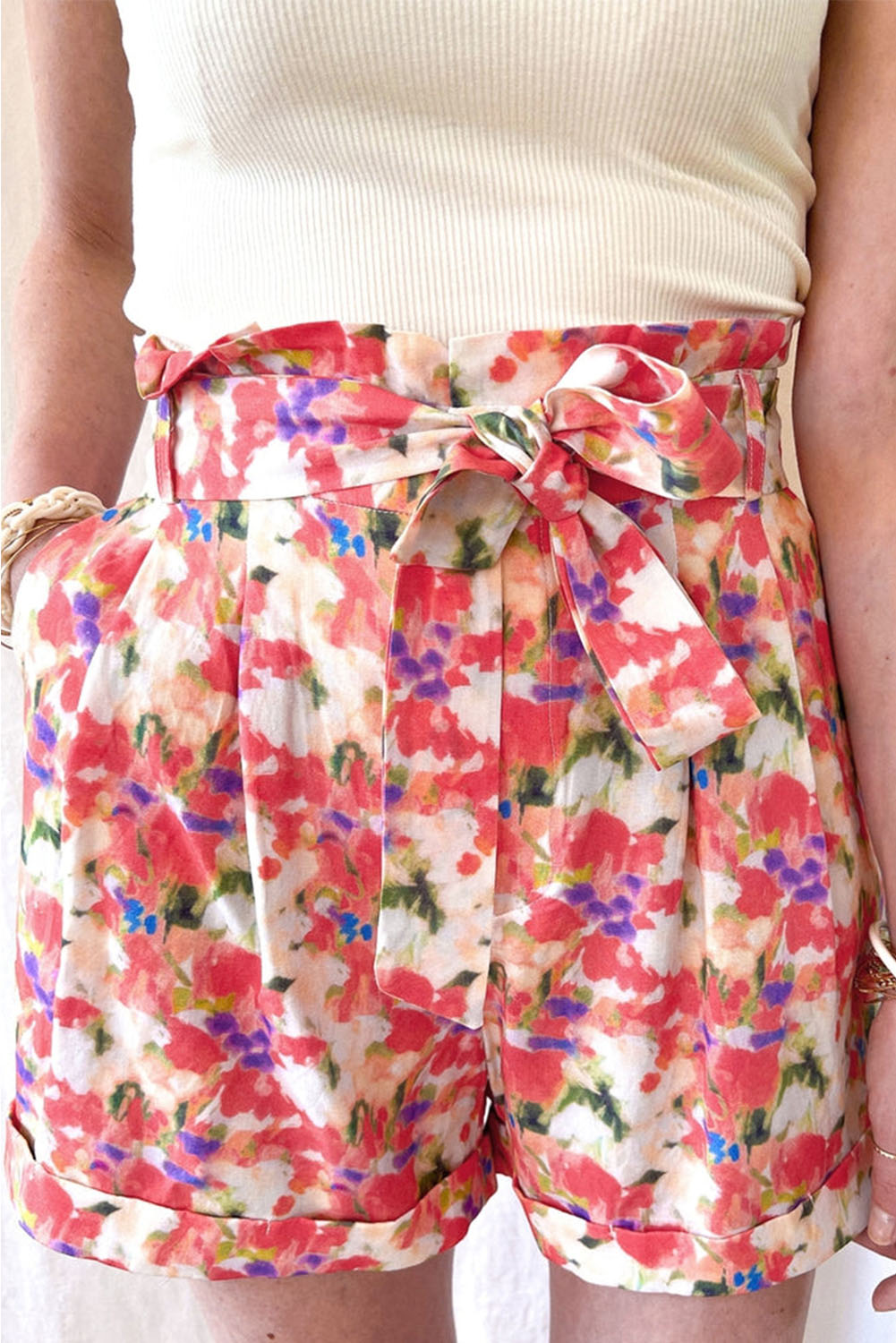 A pair of vibrant abstract floral print high waist shorts with lace-up detail, showcasing a stylish and trendy design.