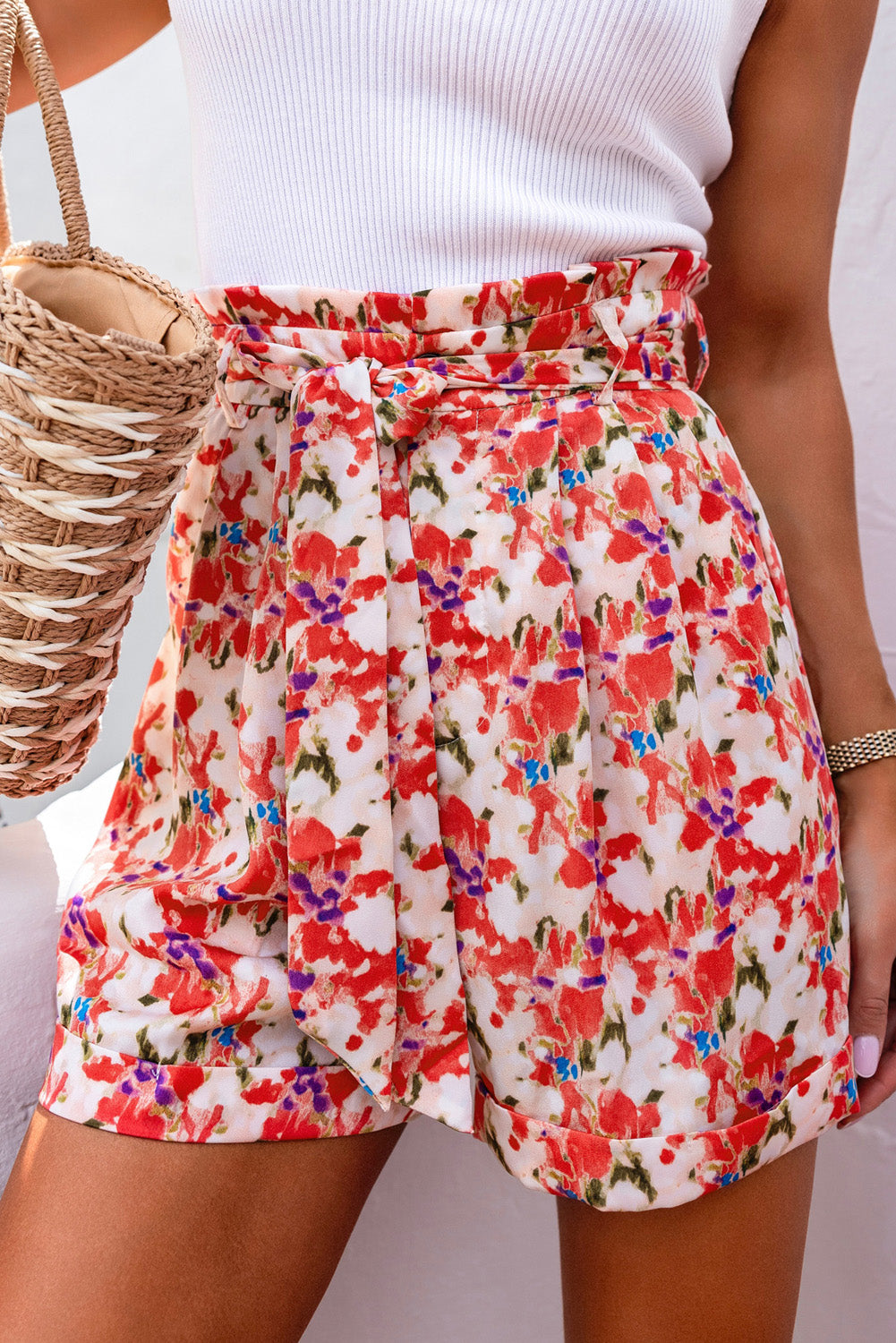 A pair of vibrant abstract floral print high waist shorts with lace-up detail, showcasing a stylish and trendy design.