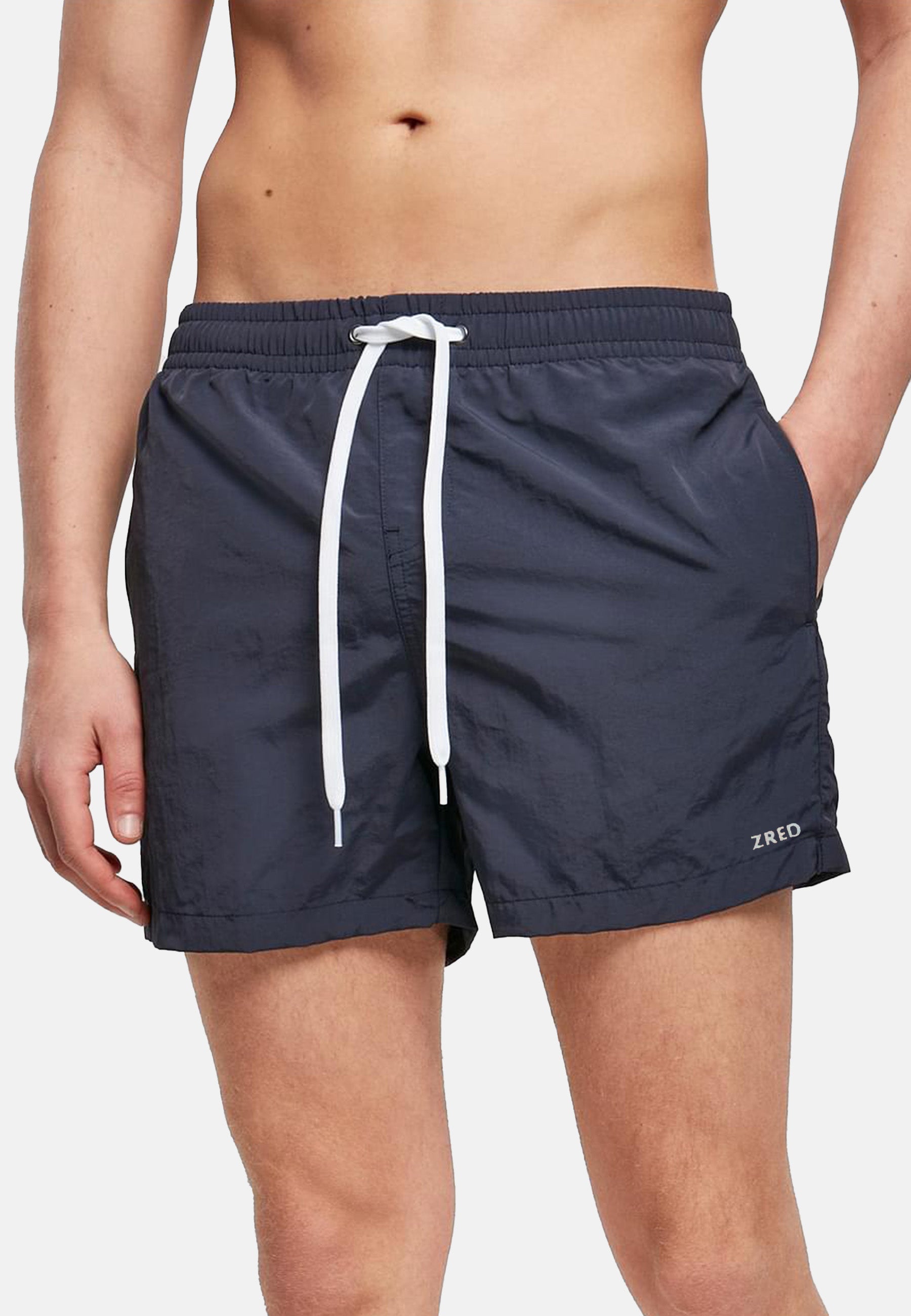 Men's Beach Shorts ICON in four stylish colors, featuring a zippered back pocket and made from lightweight, quick-drying fabric.