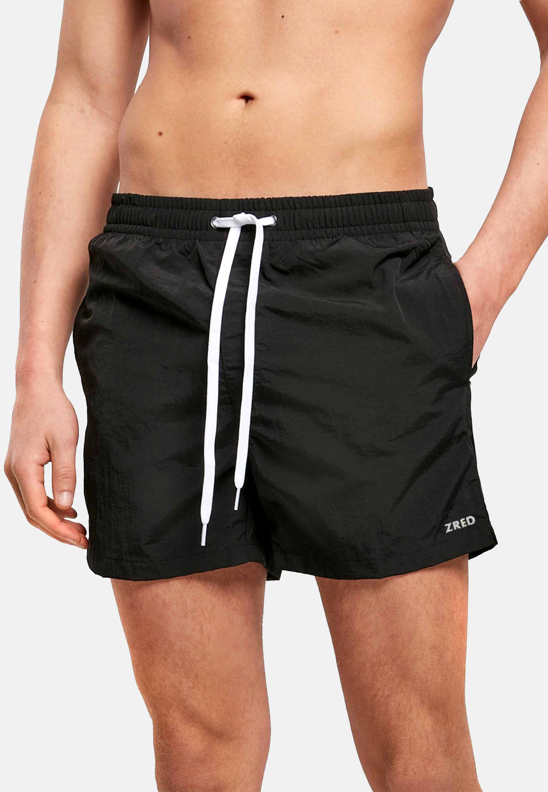 Men's Beach Shorts ICON in four stylish colors, featuring a zippered back pocket and made from lightweight, quick-drying fabric.