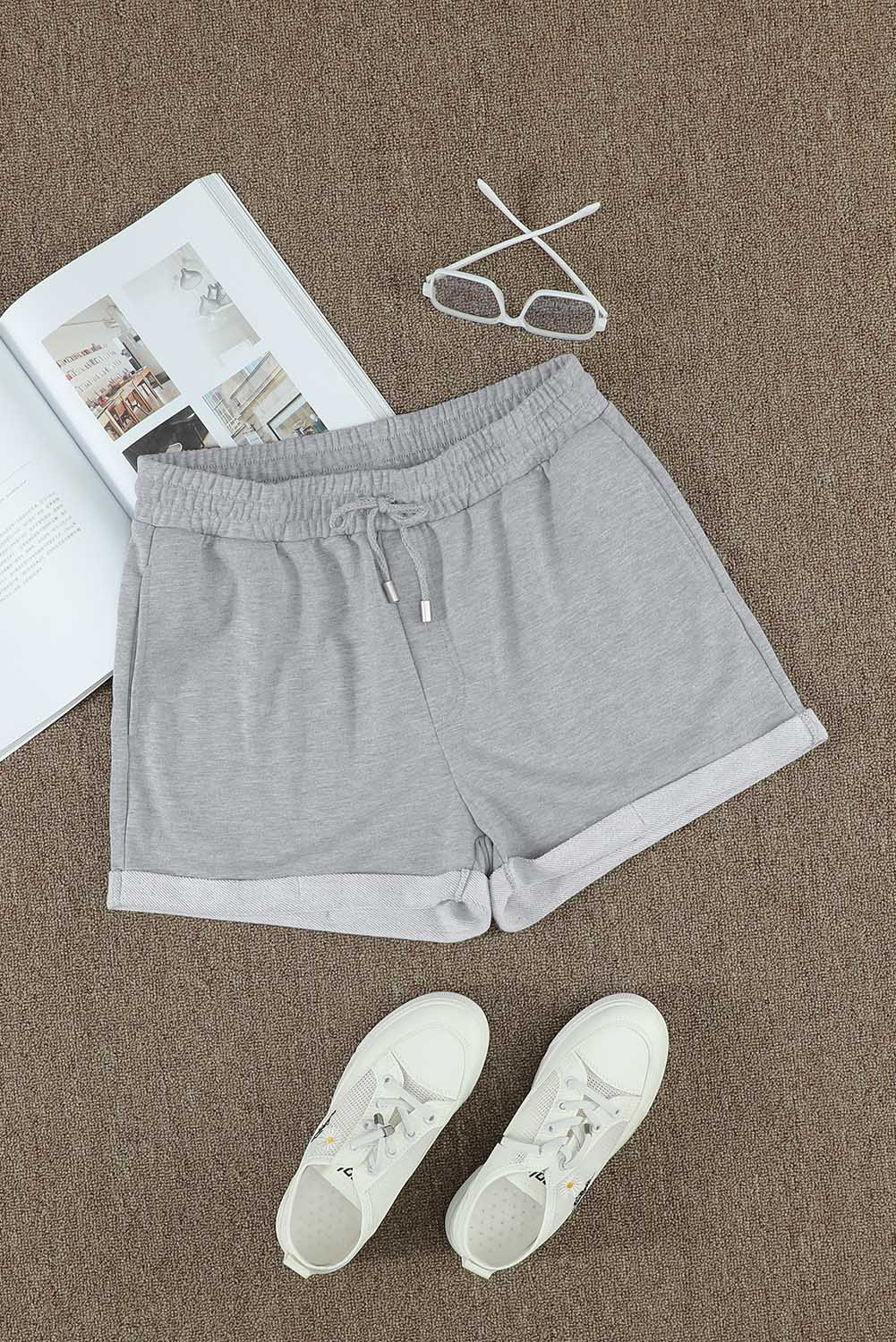 A pair of gray cuffed lounge shorts for women featuring a tie waist and side pockets, perfect for summer wear.