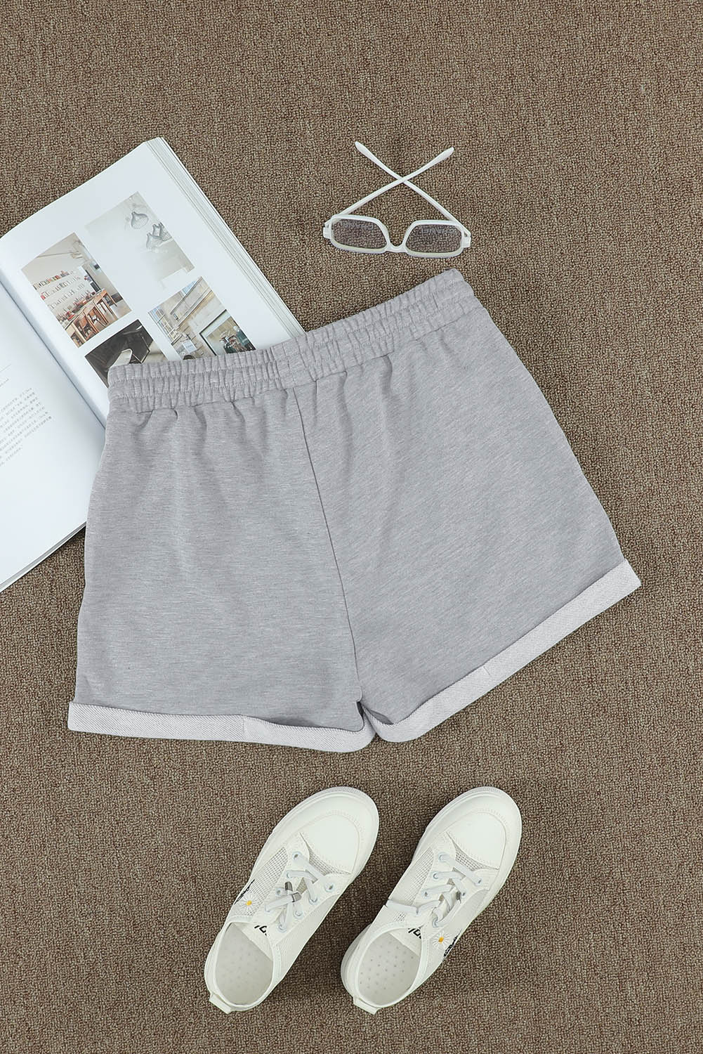 A pair of gray cuffed lounge shorts for women featuring a tie waist and side pockets, perfect for summer wear.