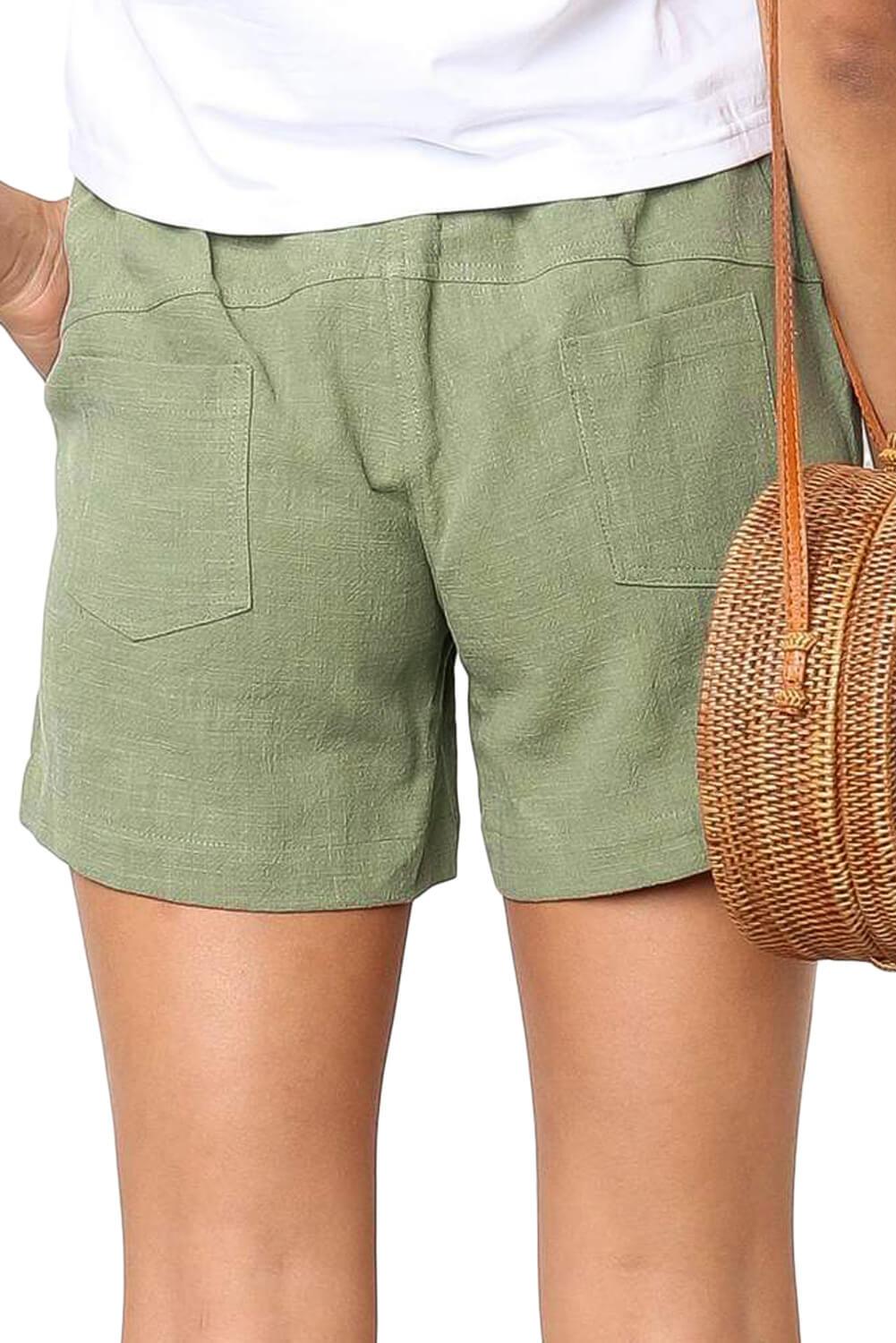 A pair of stylish green women shorts made from 100% cotton, featuring an elasticised waist with drawstring and pockets on both sides.