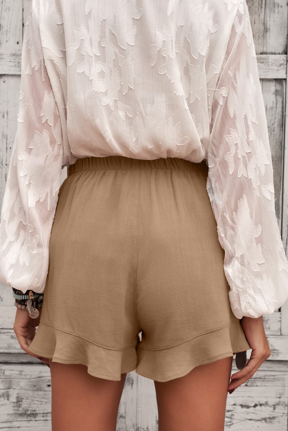 A pair of Women's Casual Pocketed Flutter Khaki Linen Cotton Shorts featuring a soft fabric, elastic waistband, and stylish ruffled hem, perfect for summer wear.