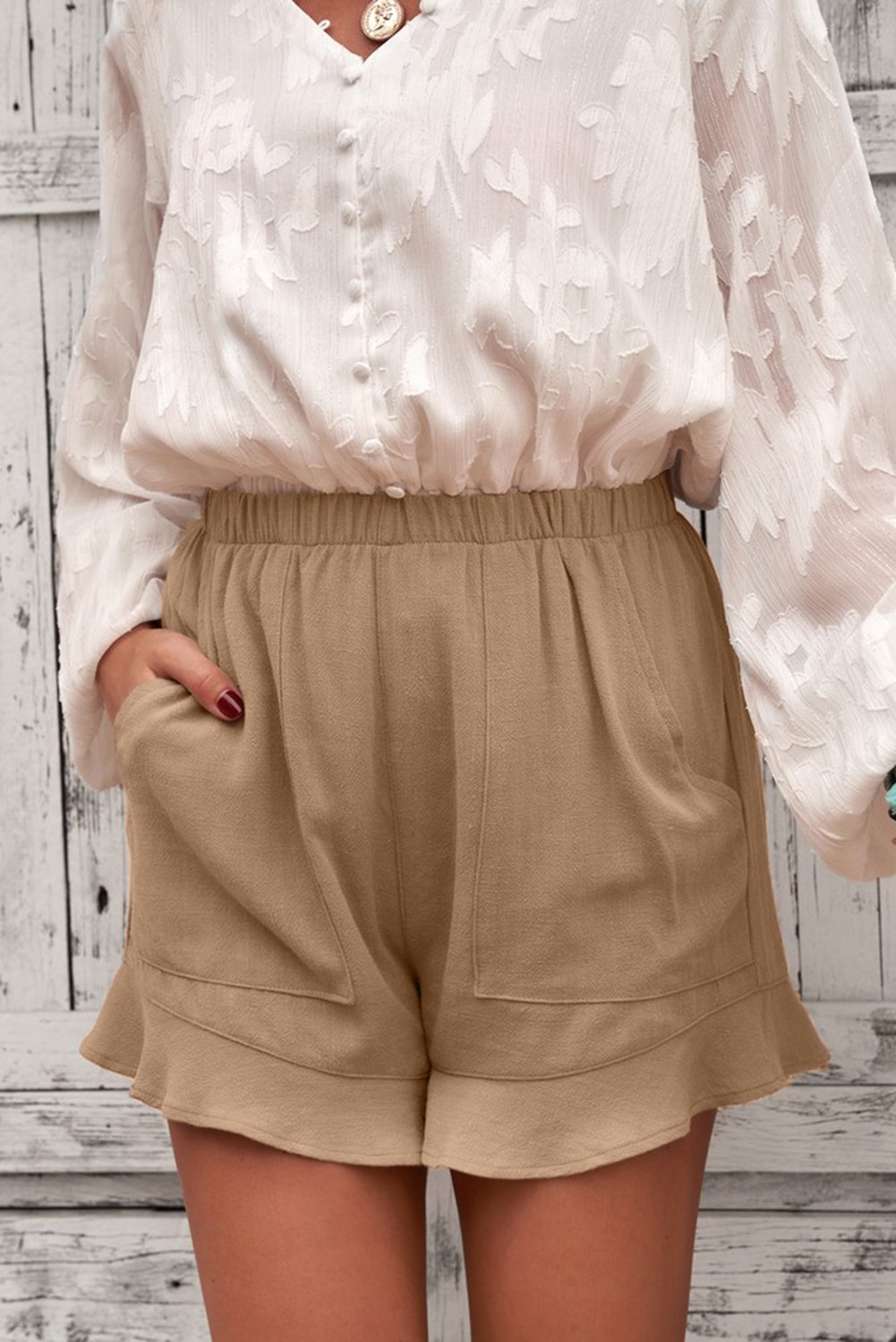 A pair of Women's Casual Pocketed Flutter Khaki Linen Cotton Shorts featuring a soft fabric, elastic waistband, and stylish ruffled hem, perfect for summer wear.