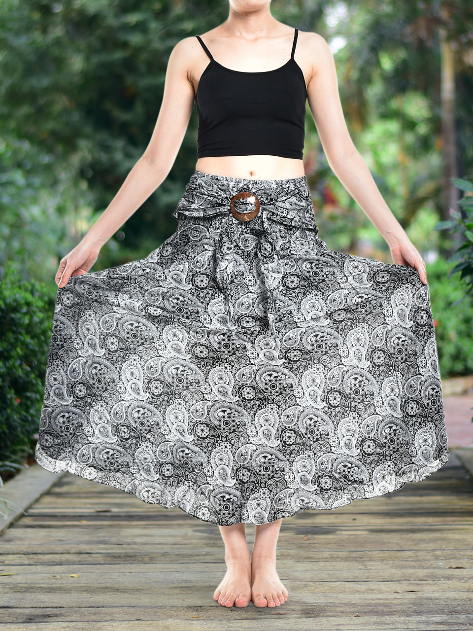 Bohotusk Black Orbit Long Skirt featuring a coconut buckle and smocked waist, styled as a strapless dress.