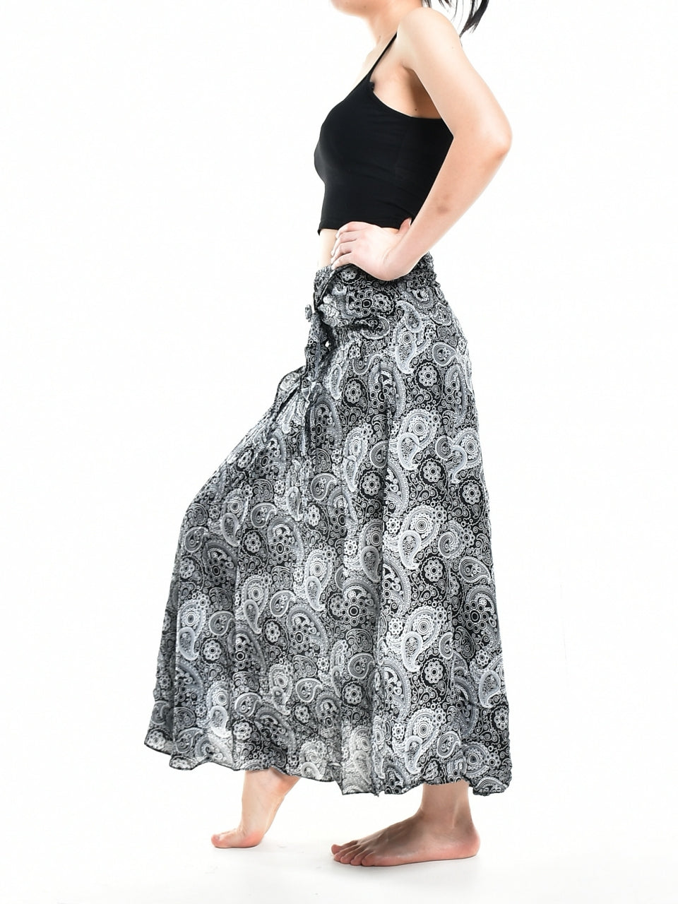 Bohotusk Black Orbit Long Skirt featuring a coconut buckle and smocked waist, styled as a strapless dress.