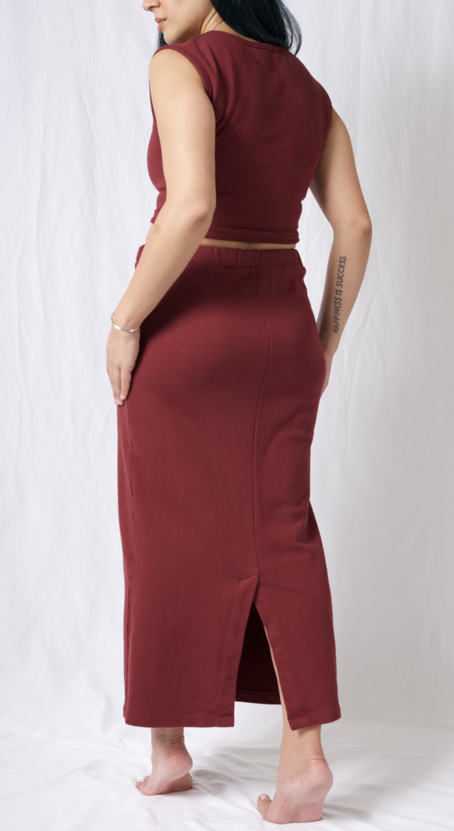 A stylish cotton midi skirt featuring an elastic waistband, deep pockets, and a braided brick red drawstring, perfect for versatile outfits.