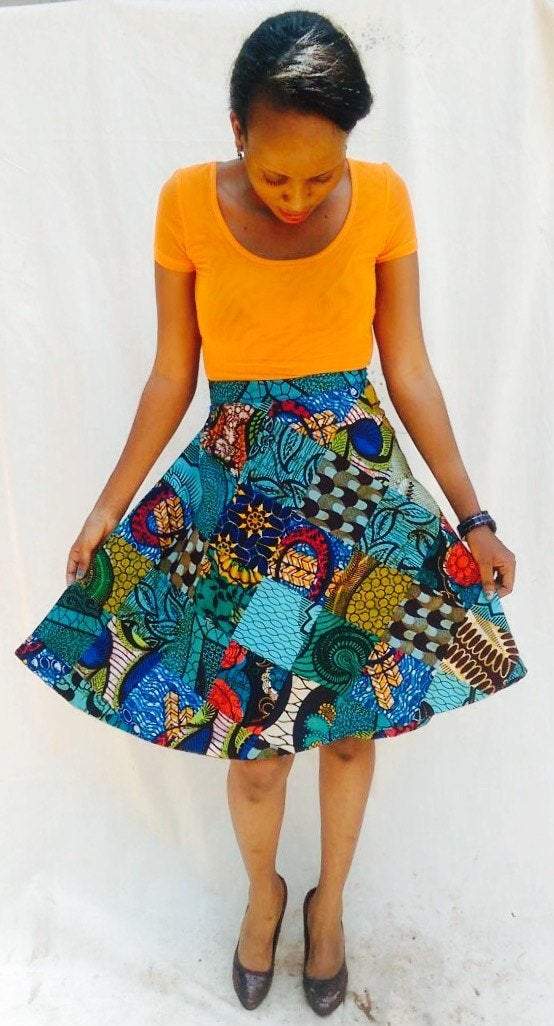 A vibrant Kitenge round women mini wrap skirt featuring unique mixed prints and two straps for a secure fit, perfect for any occasion.