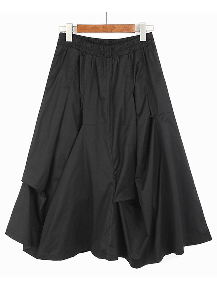 Ladies Irregular Pleated Dark Skirt showcasing unique pleated design and elastic waist, perfect for versatile styling.