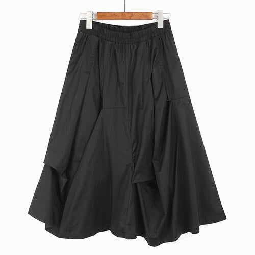 Ladies Irregular Pleated Dark Skirt showcasing unique pleated design and elastic waist, perfect for versatile styling.