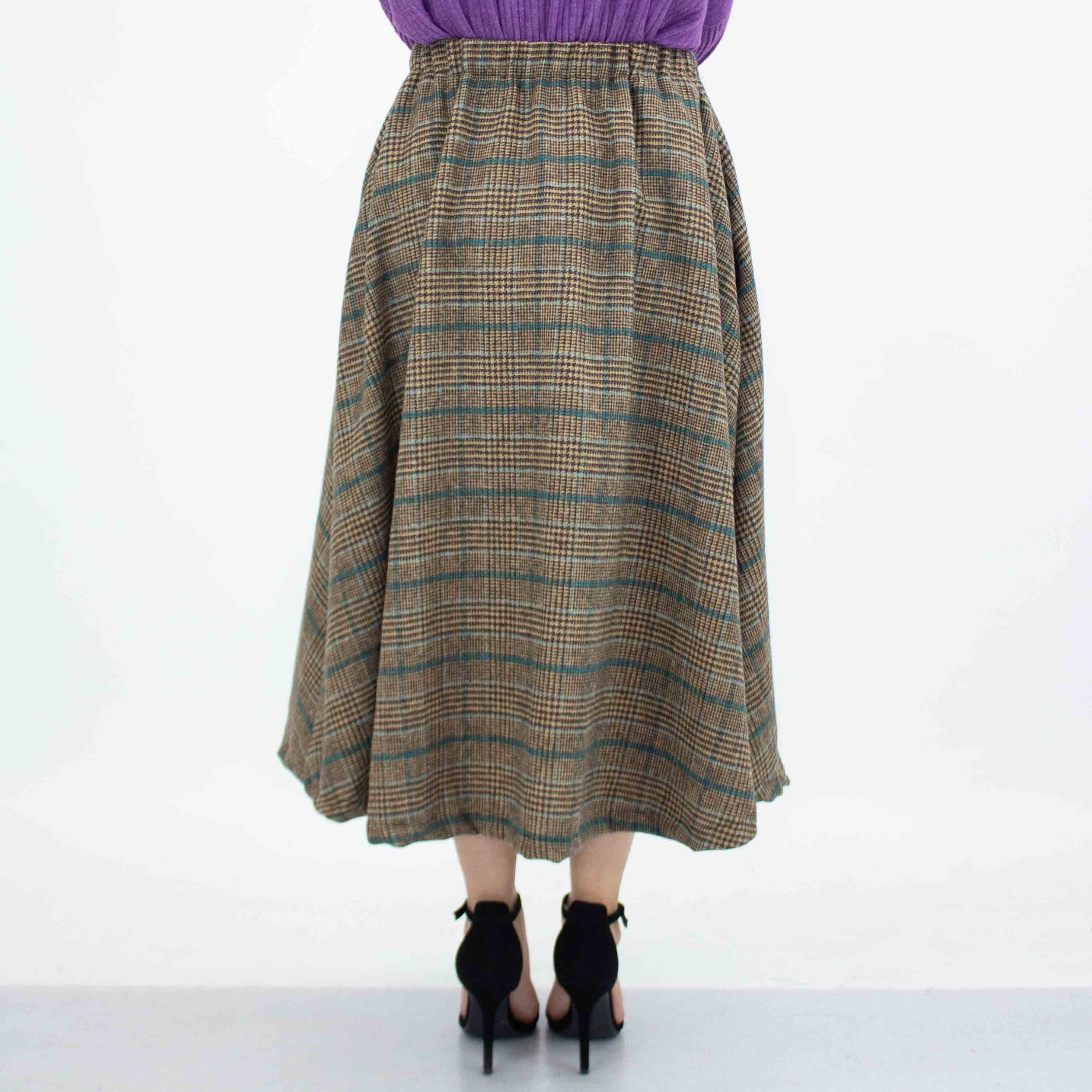 A stylish blue plaid flare midi skirt featuring an elastic waist and side pockets, perfect for casual wear.