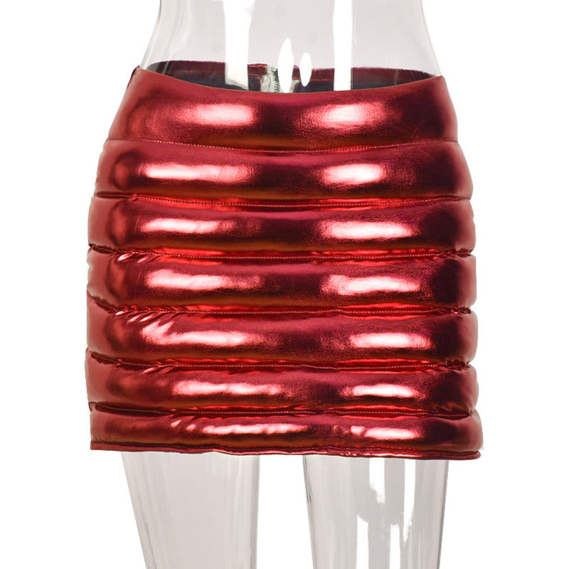 A stylish red women's puffer skirt with a metallic shiny finish, featuring a quilted design and zipper closure, perfect for winter fashion.