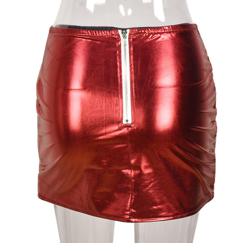 A stylish red women's puffer skirt with a metallic shiny finish, featuring a quilted design and zipper closure, perfect for winter fashion.